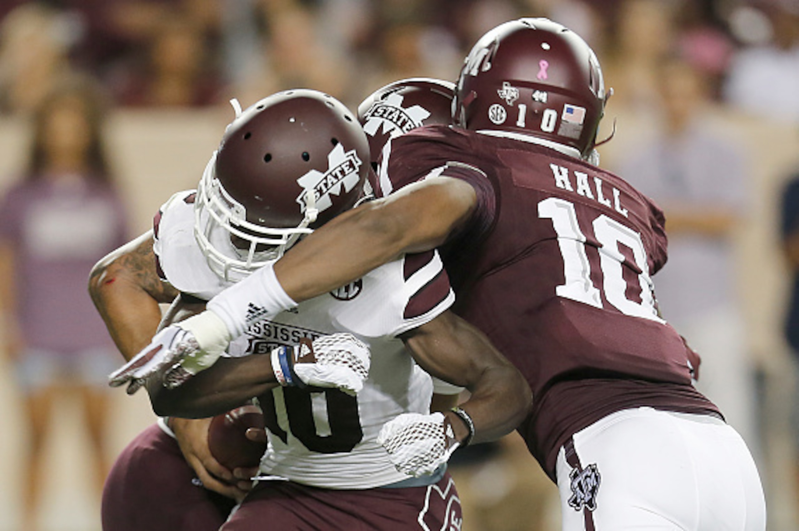 COLLEGE STATION, TX - OCTOBER 03: Daeshon Hall #10 of the Texas A&M Aggies runs over Brandon Holloway #10 of the Mississippi State Bulldogs to tackle Dak Prescott #15 in the second quarter on October 3, 2015 at Kyle Field in College Station, Texas. (Photo