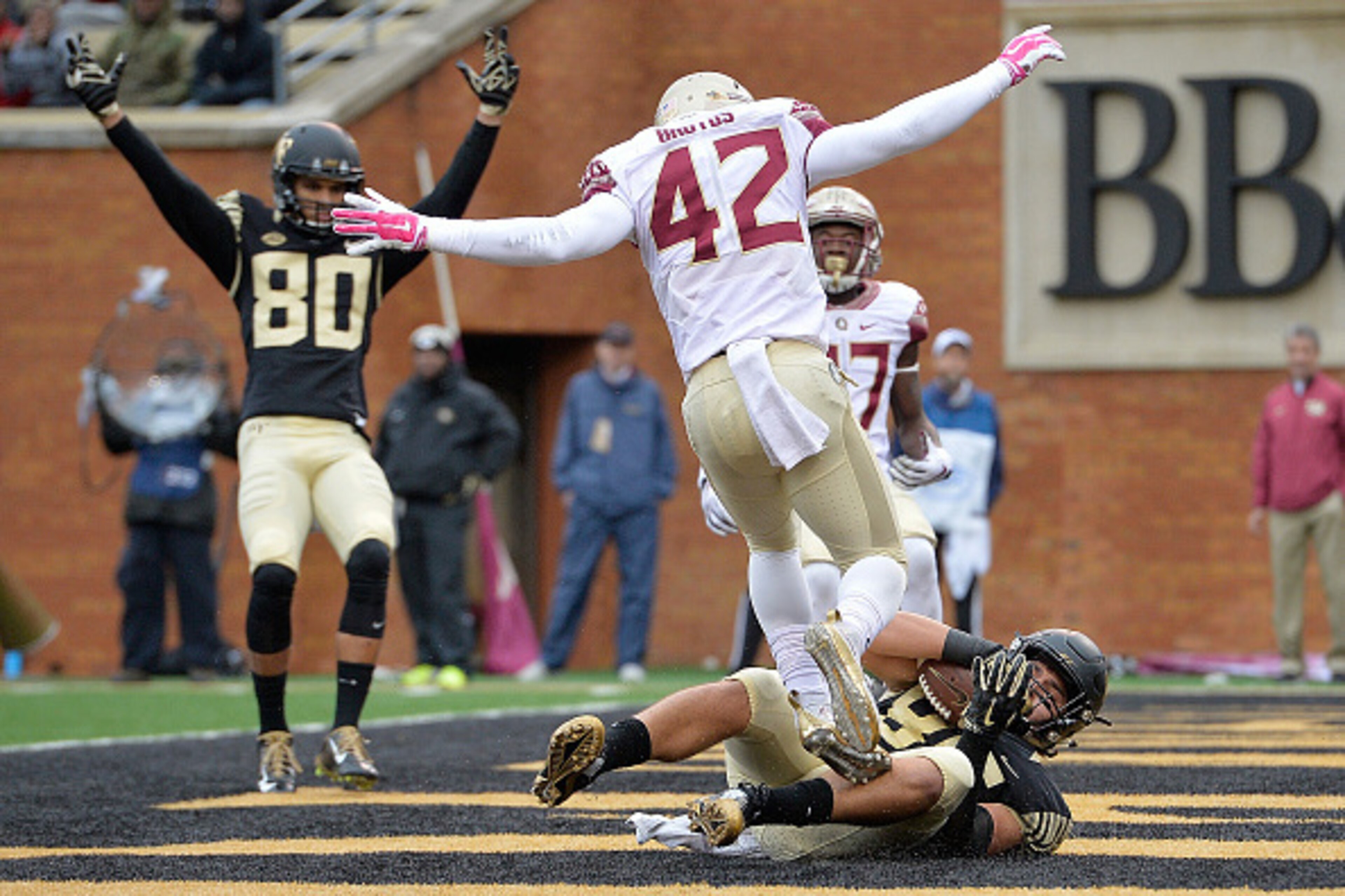 WINSTON SALEM, NC - OCTOBER 03:  K.J. Brent #80 signals touchdown on a pass to teammate Cam Serigne #85 of the Wake Forest Demon Deacons as Lamarcus Brutus #42 of the Florida State Seminoles defends during their game at BB&T Field on October 3, 2015 in Wi