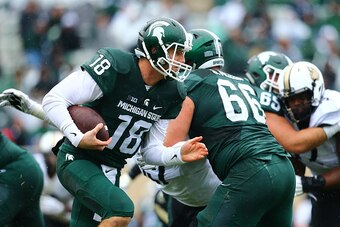 EAST LANSING, MI - OCTOBER 3: Connor Cook #18 of the Michigan State Spartans runs the ball in the third quarter against the Purdue Boilermakers at Spartan Stadium on October 3, 2015 in East Lansing, Michigan. (Photo by Rey Del Rio/Getty Images)