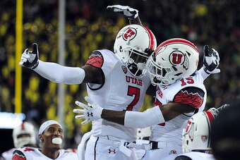 EUGENE, OR - SEPTEMBER 26: Defensive back Andre Godfrey #7 celebrates with defensive back Dominique Hatfield #15 of the Utah Utes after Hatfield intercepted a pass in the end zone in the third quarter of the game against the Oregon Ducks at Autzen Stadium