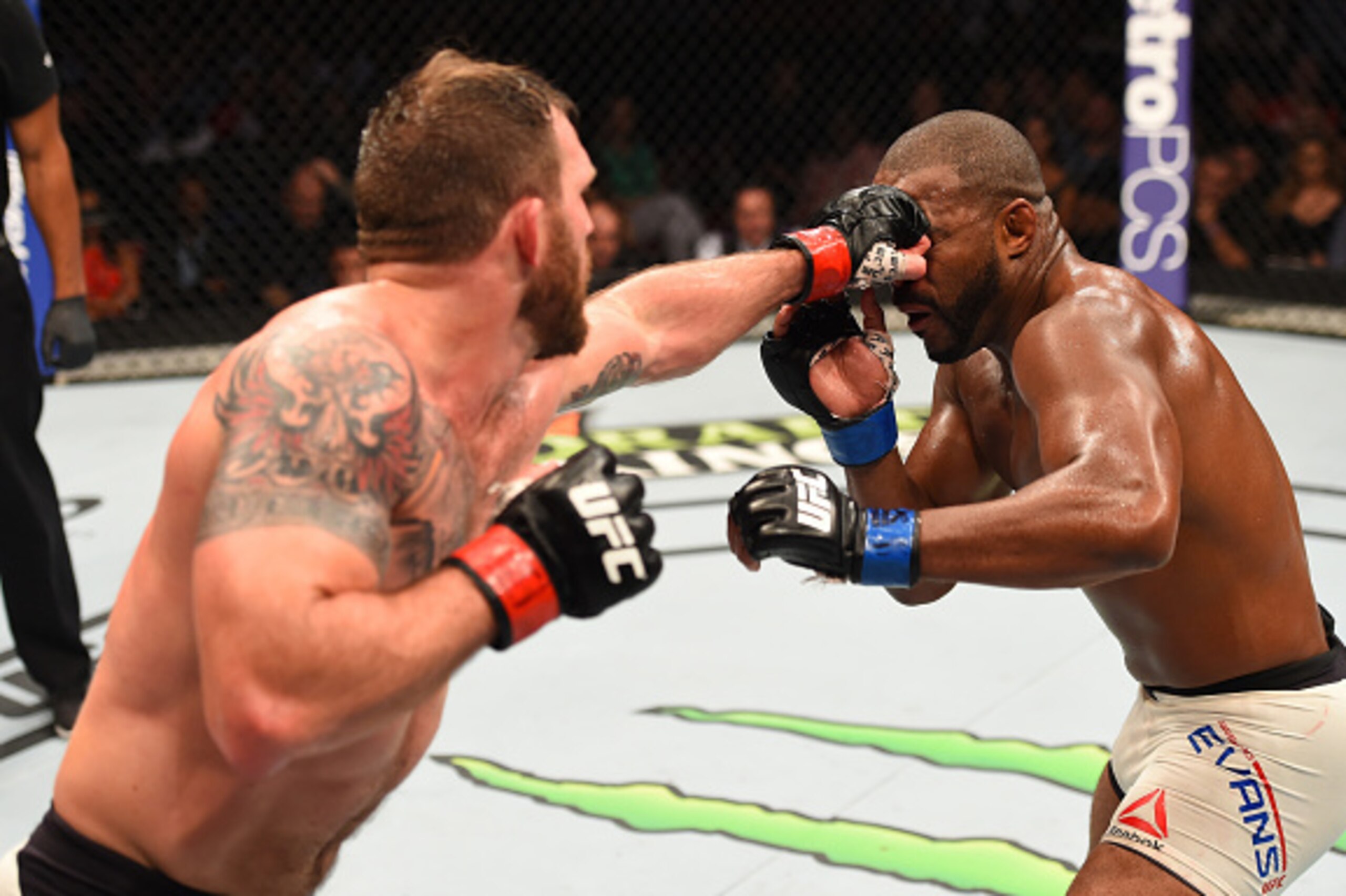 HOUSTON, TX - OCTOBER 03:  (L-R) Ryan Bader punches Rashad Evans in their light heavyweight bout during the UFC 192 event at the Toyota Center on October 3, 2015 in Houston, Texas. (Photo by Josh Hedges/Zuffa LLC/Zuffa LLC via Getty Images)