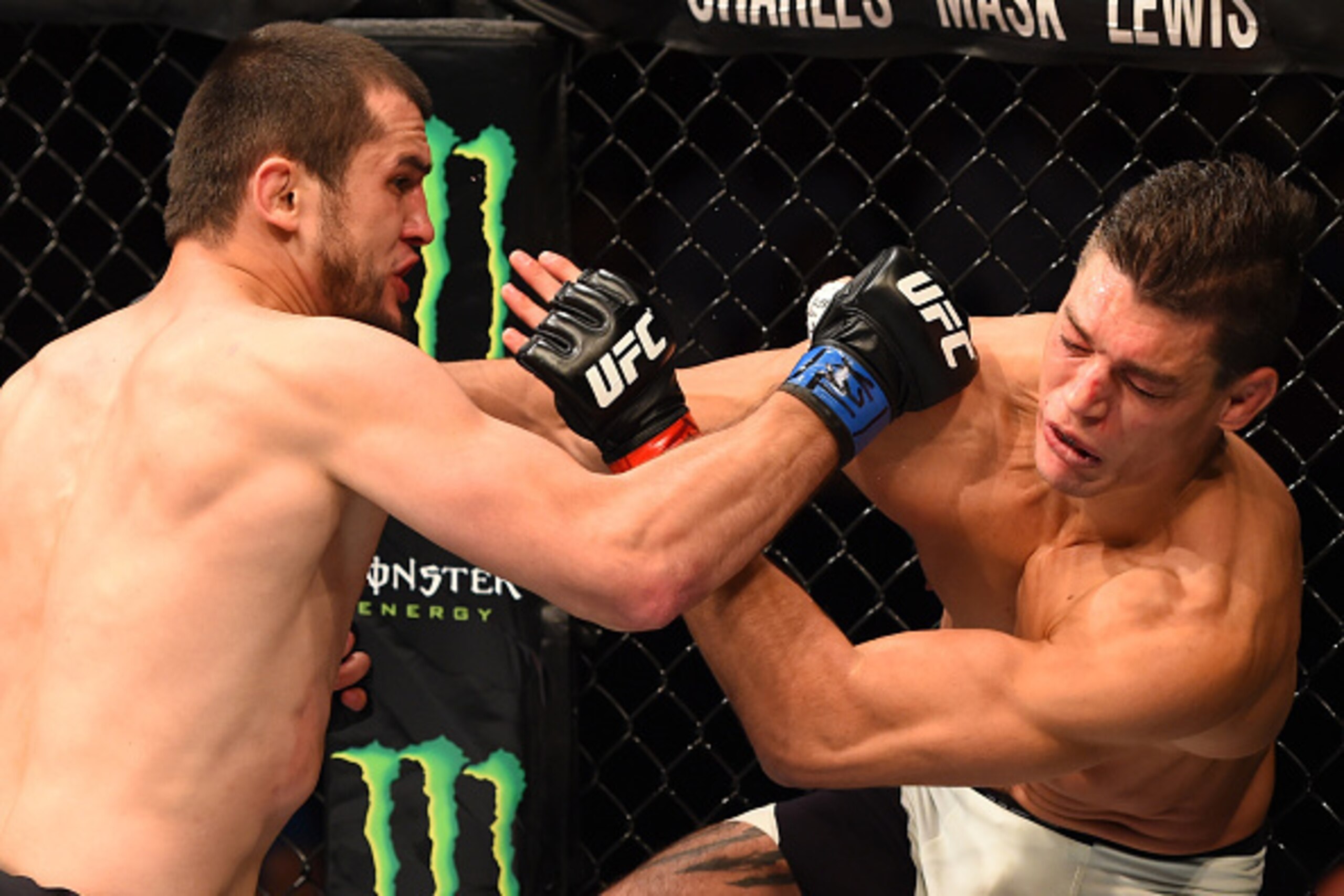 HOUSTON, TX - OCTOBER 03:  (L-R) Albert Tumenov punches Alan Jouban in their welterweight bout during the UFC 192 event at the Toyota Center on October 3, 2015 in Houston, Texas. (Photo by Josh Hedges/Zuffa LLC/Zuffa LLC via Getty Images)