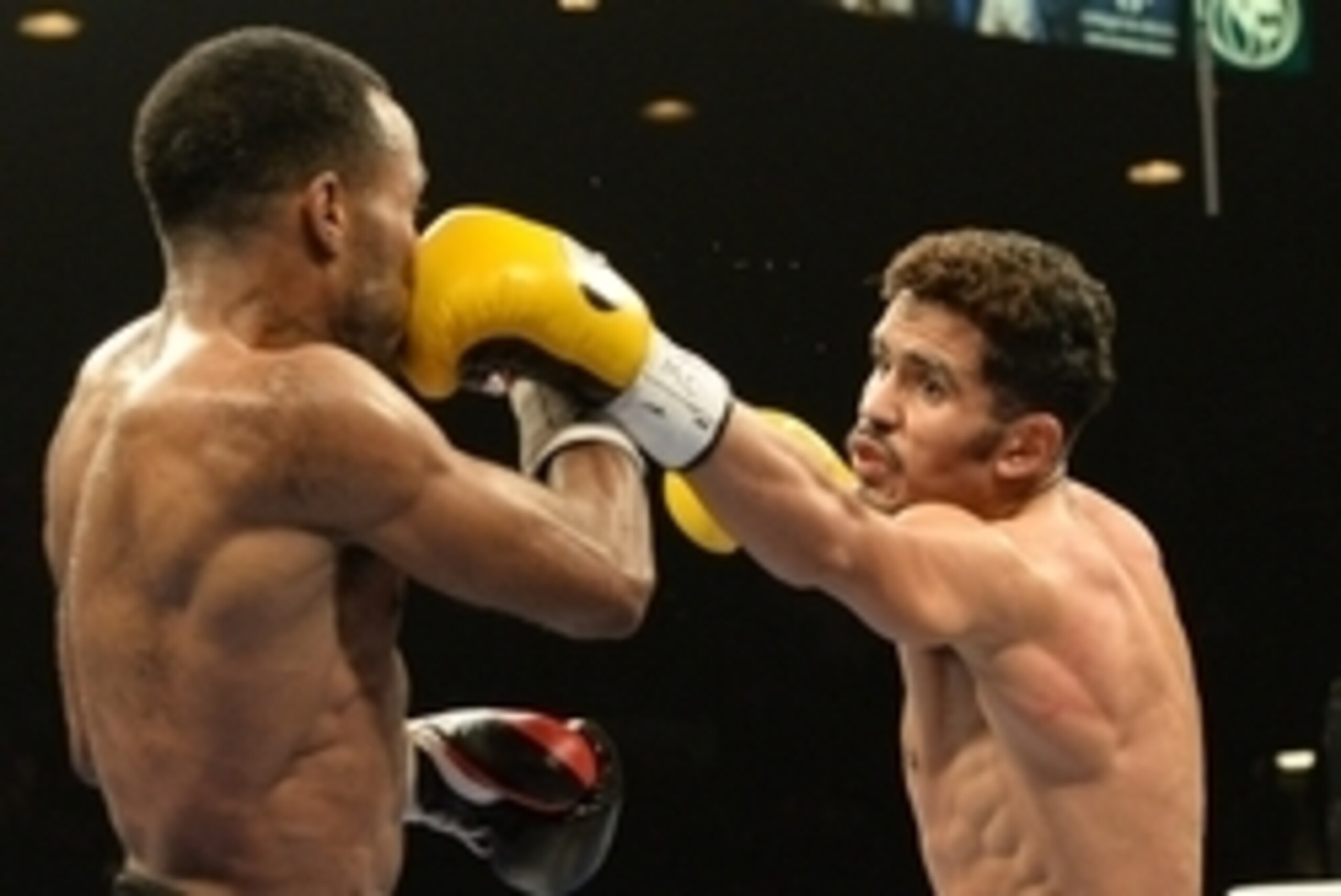 Sep 13, 2014; Las Vegas, NV, USA;  Miguel Vazquez (yellow gloves) and Mickey Bey (black gloves) during their Middleweight fight at the MGM Grand Garden Arena. Mandatory Credit: Jayne Kamin-Oncea-USA TODAY Sports