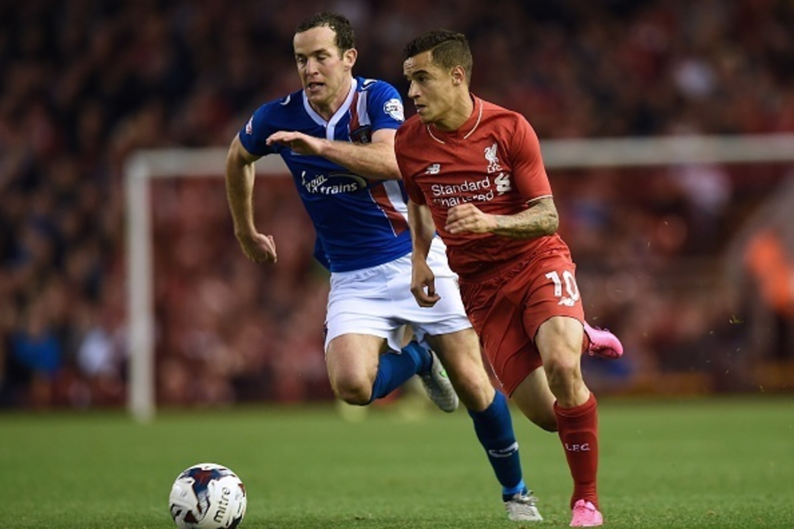 Carlisle United's English midfielder Luke Joyce (L) vies with Liverpool's Brazilian midfielder Philippe Coutinho during the English League Cup third round football match between Liverpool and Carlisle United at Anfield in Liverpool, north west England on 