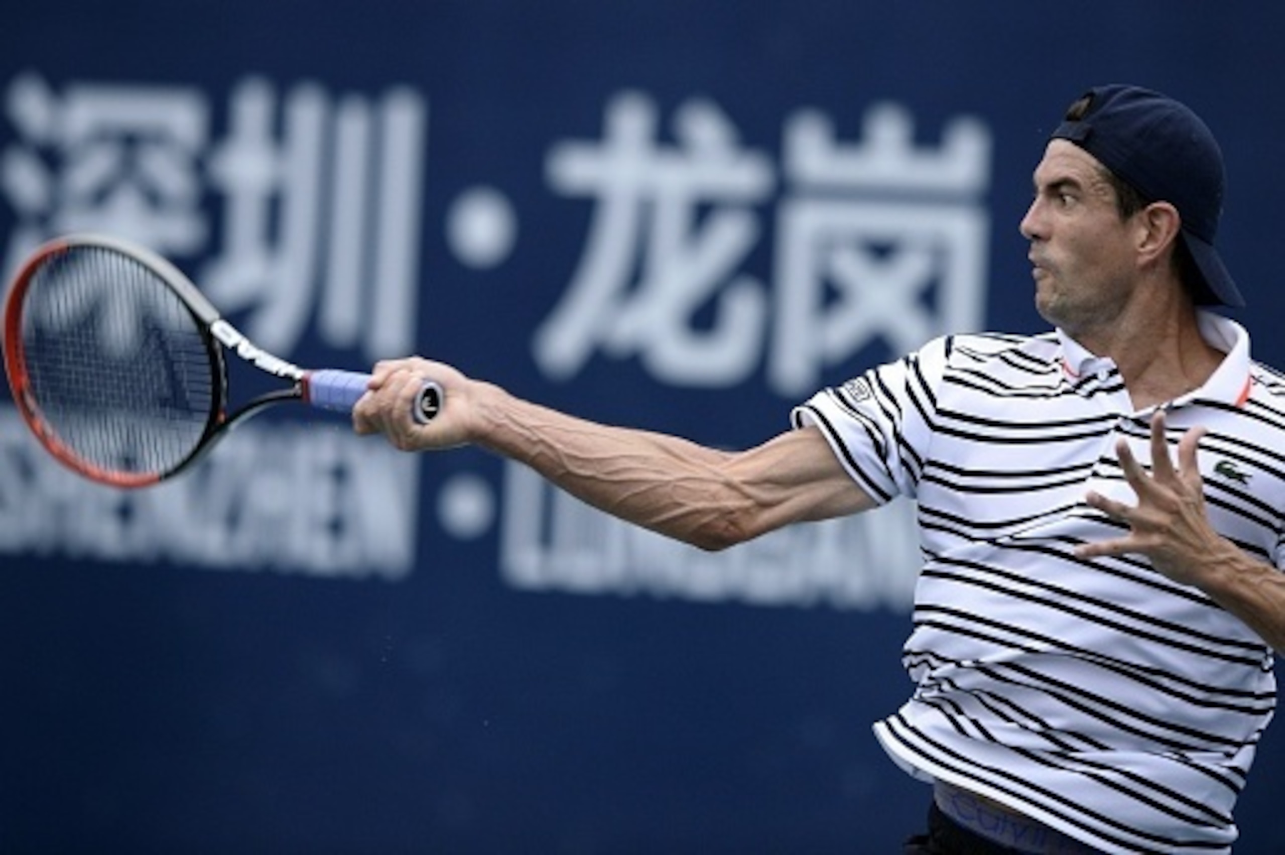 Guillermo Garcia-Lopez of Spain returns a shot against Lukas Rosol of Czech Republic during their men's singles quarterfinal match at the Shenzhen Open tennis championship in Shenzhen, southern China's Guangdong province on October 1, 2015.               