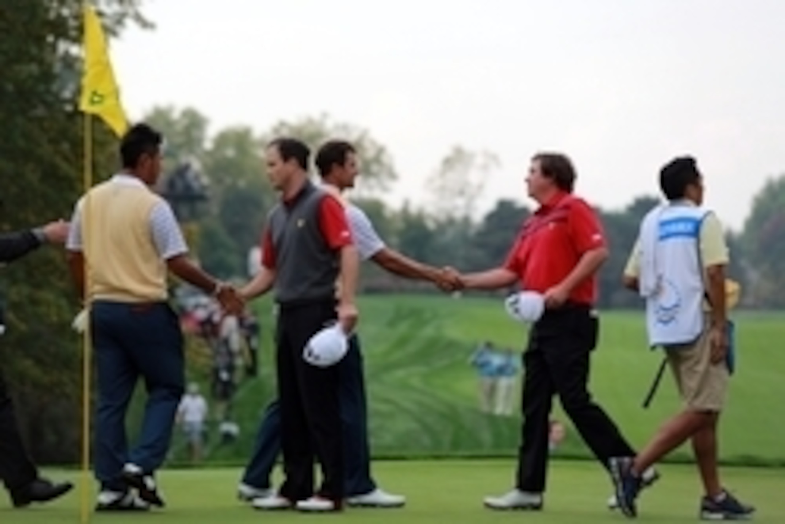 Oct 5, 2013; Dublin, OH, USA; Hideki Matsuyama, Zach Johnson, Adam Scott and Jason Dufner shake hands after their in the second round of the Presidents Cup at Muirfield Village Golf Club. Mandatory Credit: Allan Henry-USA TODAY Sports