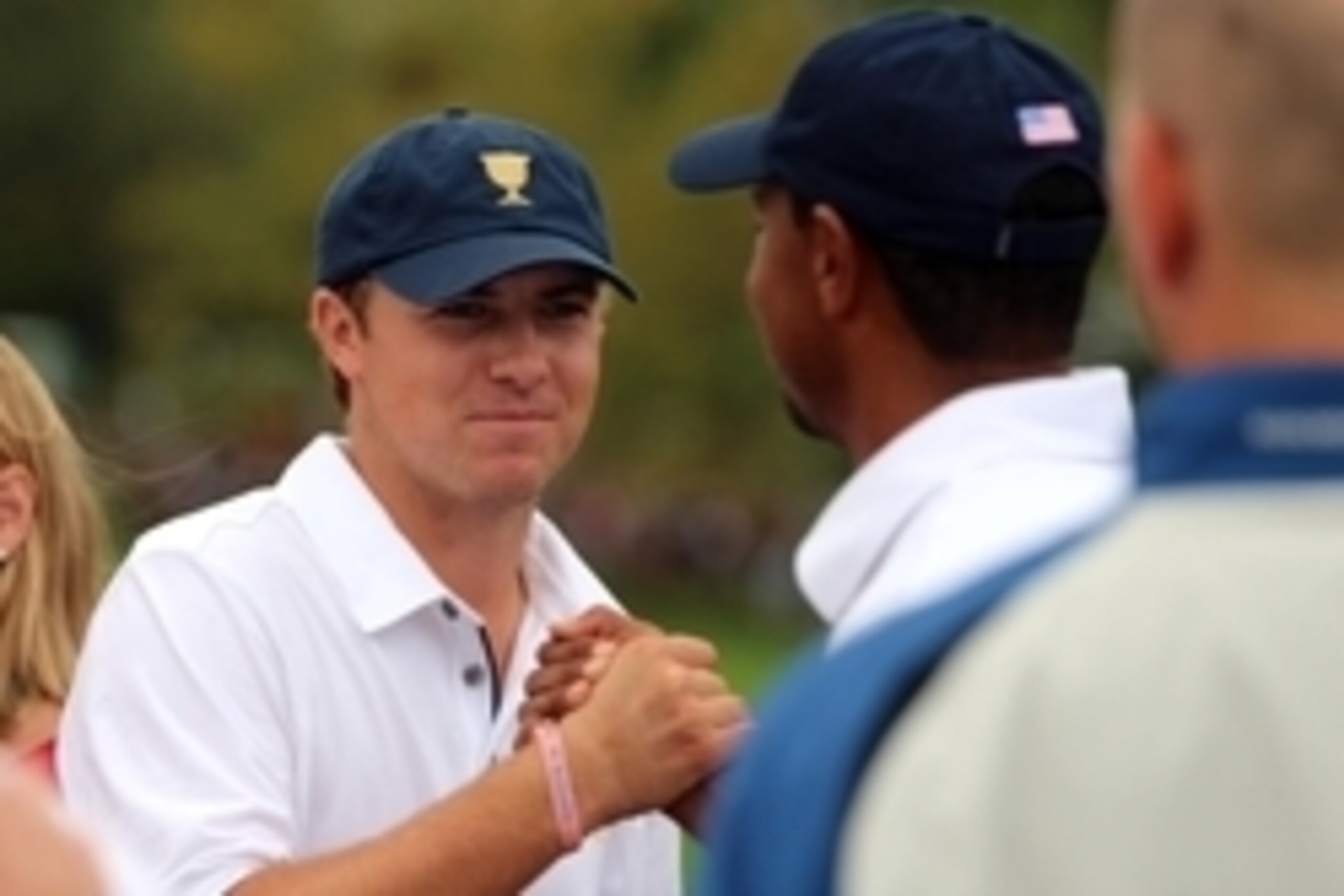 Oct 6, 2013; Dublin, OH, USA; Jordan Spieth and Tiger Woods celebrate after winning the Presidents Cup at Muirfield Village Golf Club. Mandatory Credit: Allan Henry-USA TODAY Sports