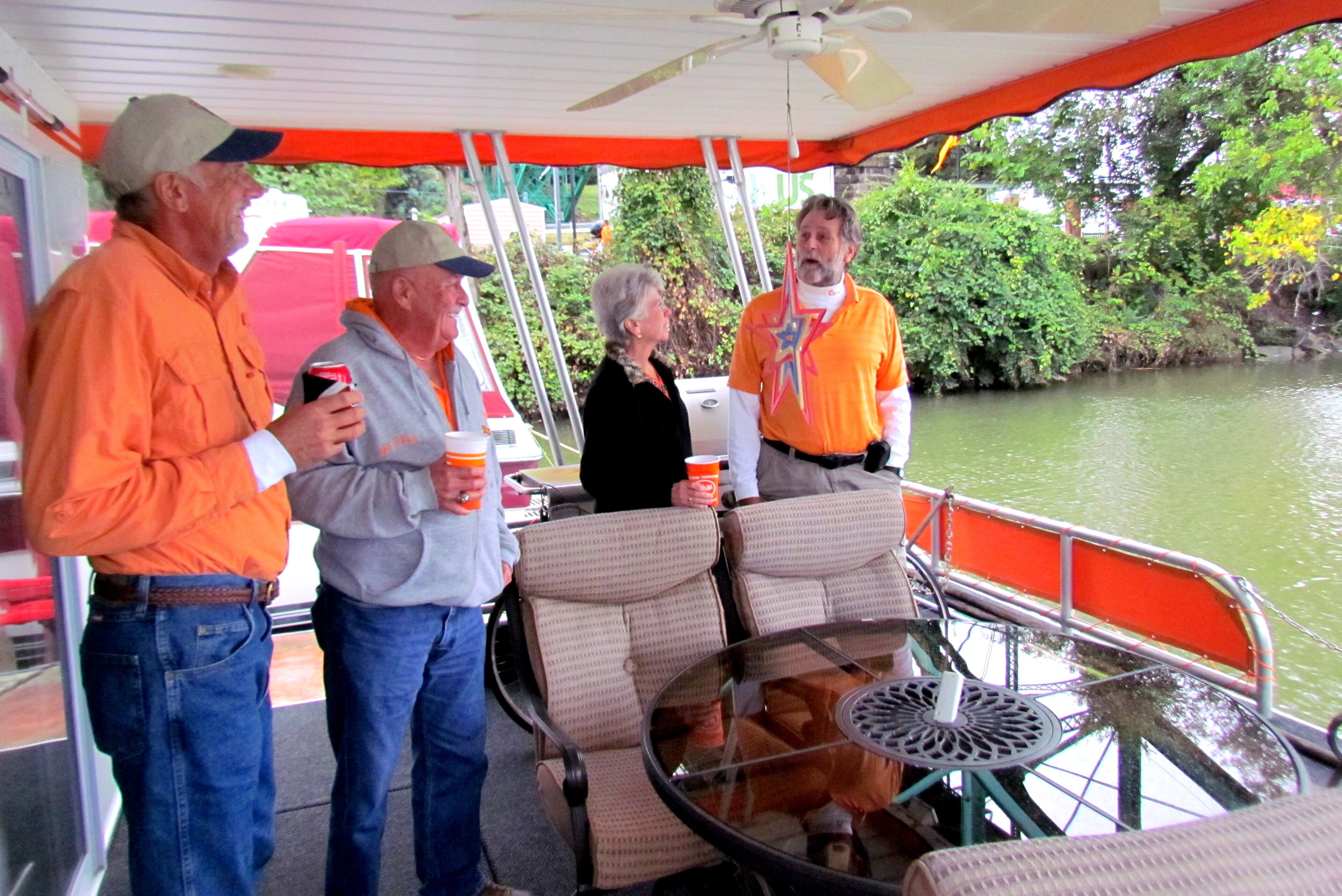Caldwell (far right) sometimes entertains friends on his houseboat. (From left) Gary Moffatt, Len Johnson and Edna Johnson chat with Caldwell. Caldwell (far right) sometimes entertains friends on his houseboat. (From left) Gary Moffatt, Len Johnson and Edna Johnson chat with Caldwell.