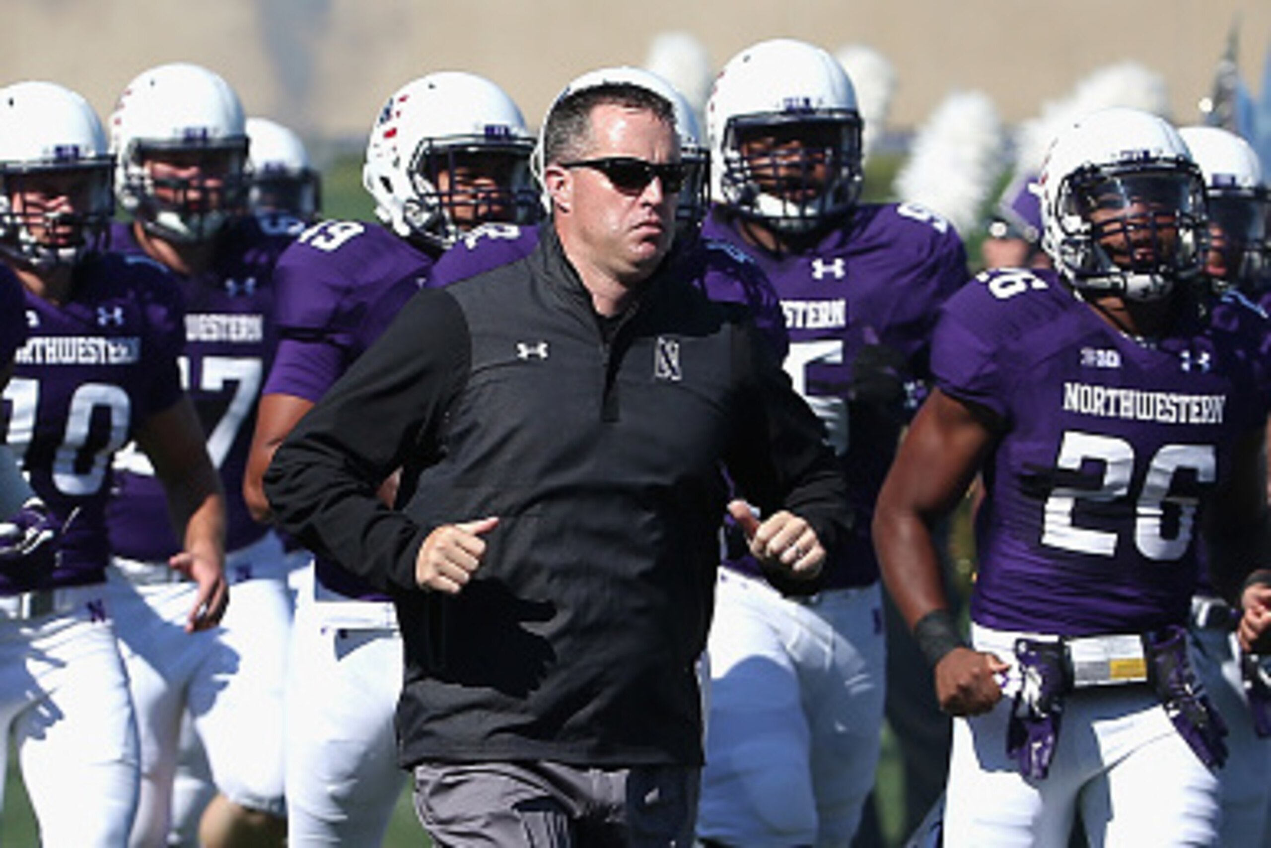 EVANSTON, IL - SEPTEMBER 12: Head coach Pat Fitzgerald of the Northwestern Wildcats runs onto the field with his team before a game against the Eastern Illinois Panthers at Ryan Field on September 12, 2015 in Evanston, Illinois. Northwestern defeated Eas EVANSTON, IL - SEPTEMBER 12: Head coach Pat Fitzgerald of the Northwestern Wildcats runs onto the field with his team before a game against the Eastern Illinois Panthers at Ryan Field on September 12, 2015 in Evanston, Illinois. Northwestern defeated Eas