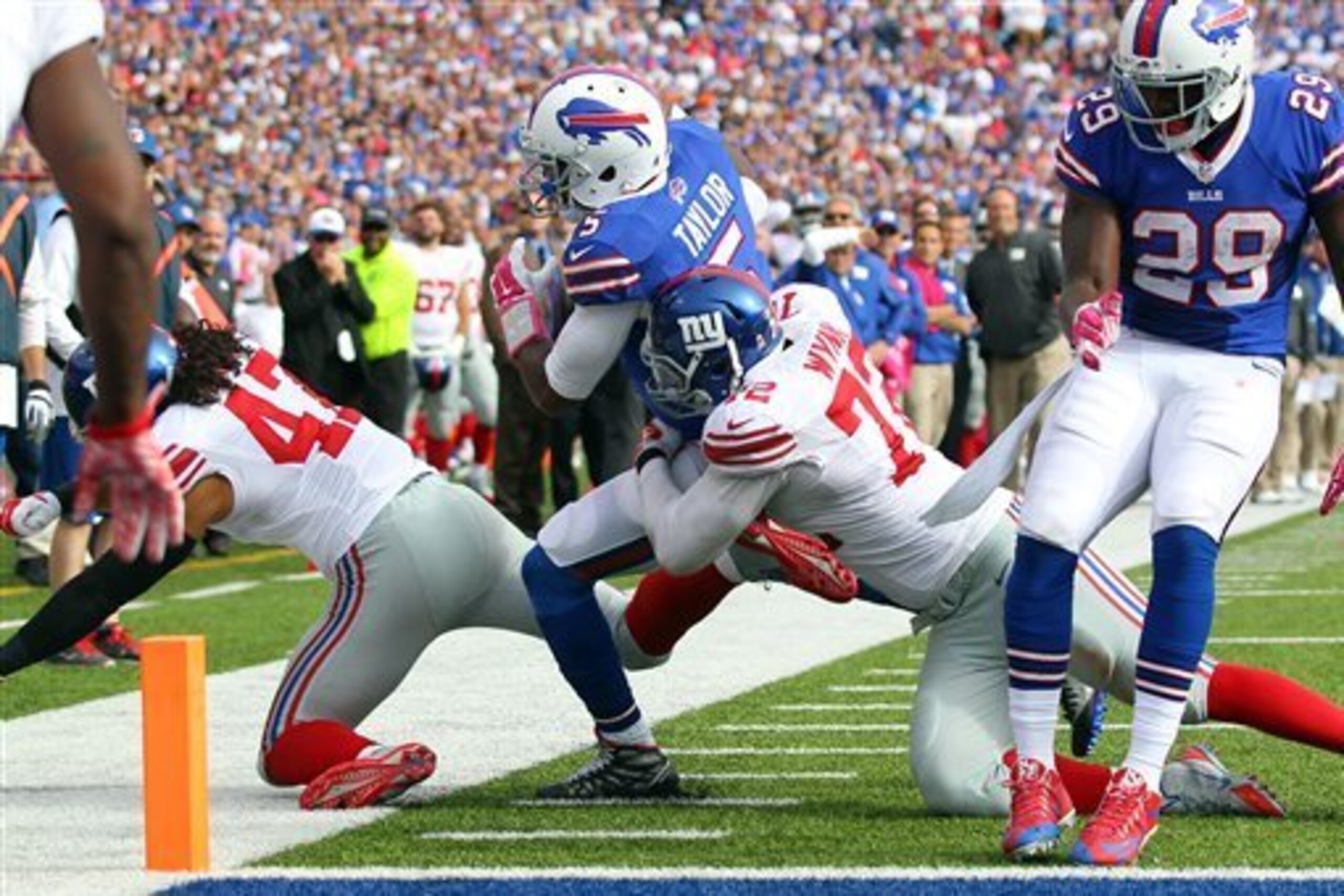 Kerry Wynn stops Bills quarterback Tyrod Taylor from scoring.