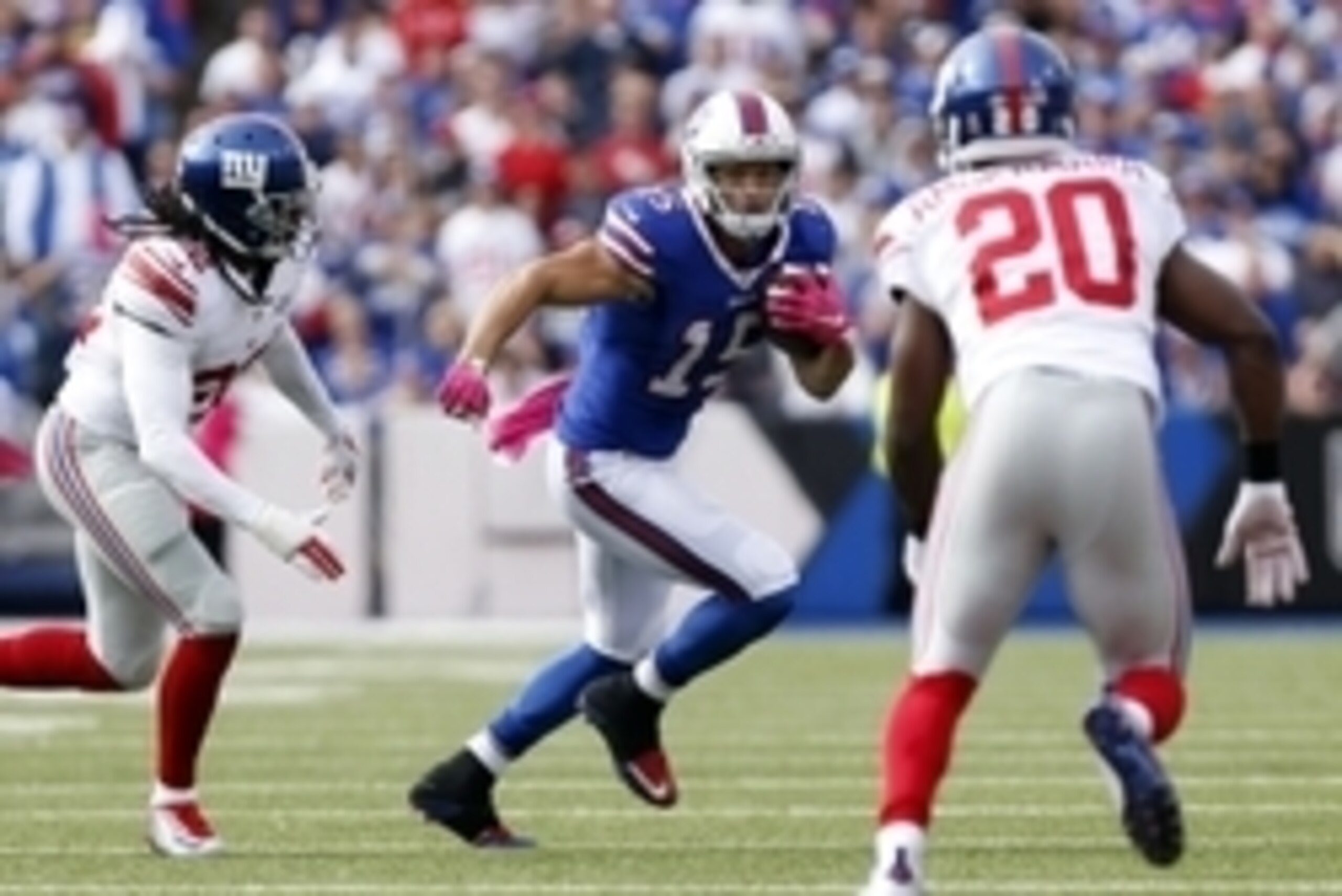 Oct 4, 2015; Orchard Park, NY, USA; Buffalo Bills wide receiver Chris Hogan (15) runs after a catch as New York Giants strong safety Brandon Meriweather (22) and cornerback Prince Amukamara (20) defends during the second half at Ralph Wilson Stadium. Gian