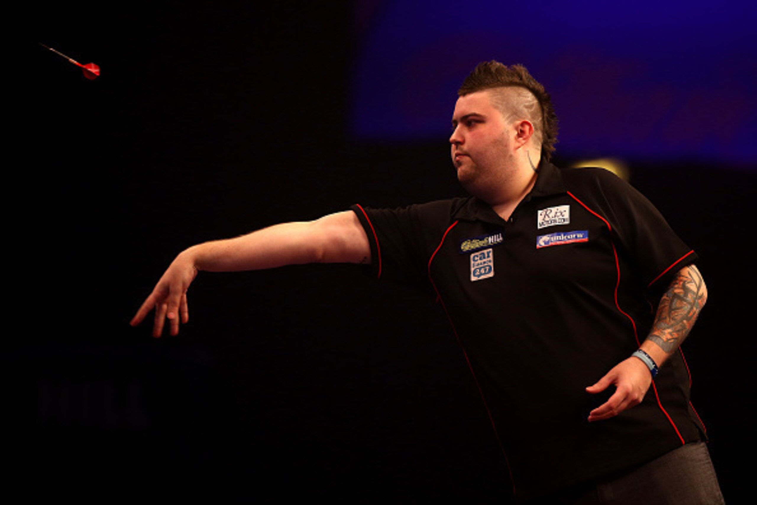 LONDON, ENGLAND - DECEMBER 30: Michael Smith of England in action during his third round match against Stephen Bunting of England during the William Hill PDC World Darts Championships on Day Ten at Alexandra Palace on December 30, 2014 in London, England.