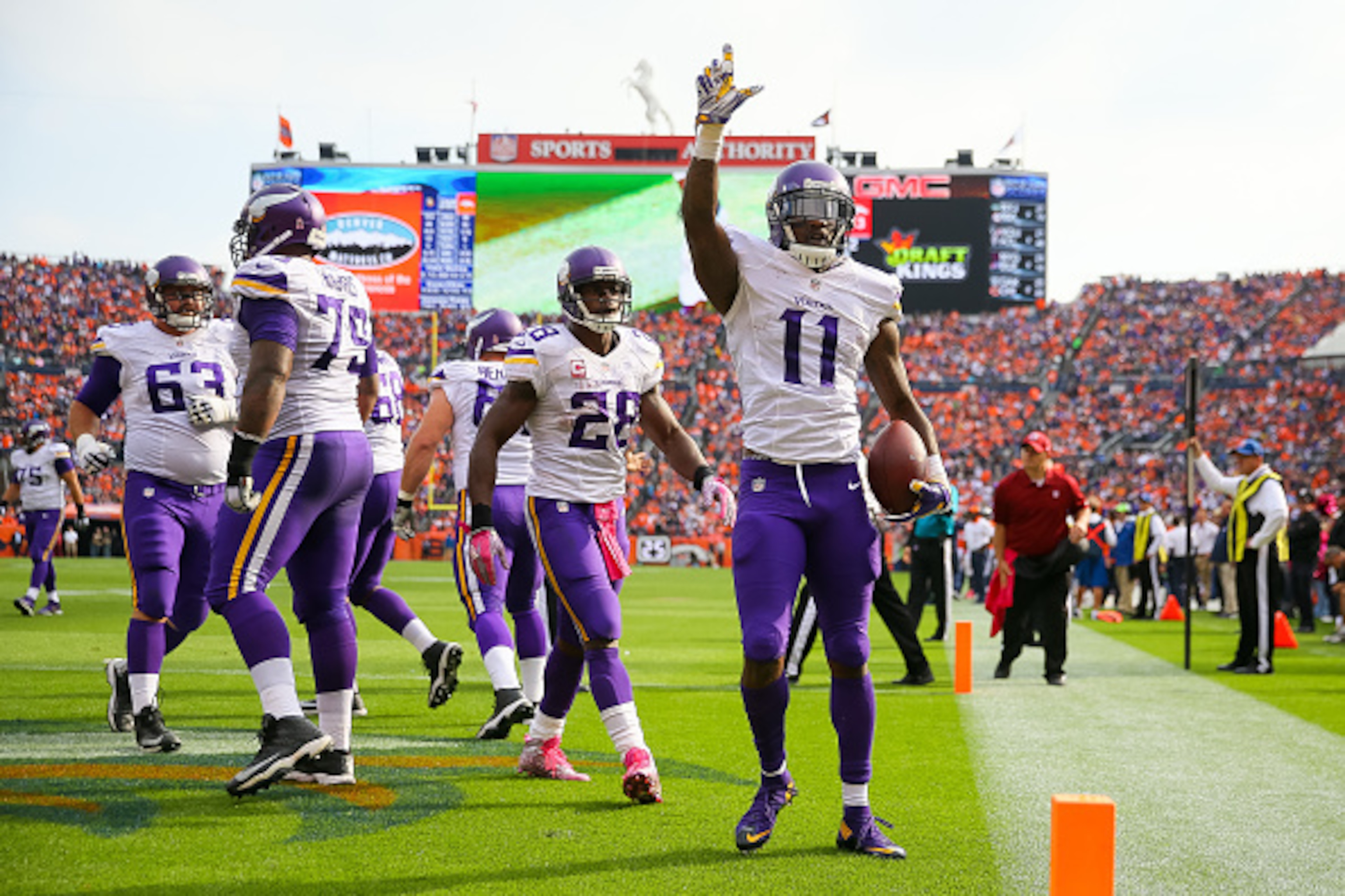 DENVER, CO - OCTOBER 4:  Wide receiver Mike Wallace #11 of the Minnesota Vikings celebrates after catching a pass for a second quarter touchdown against the Denver Broncos during a game at Sports Authority Field at Mile High on October 4, 2015 in Denver, 