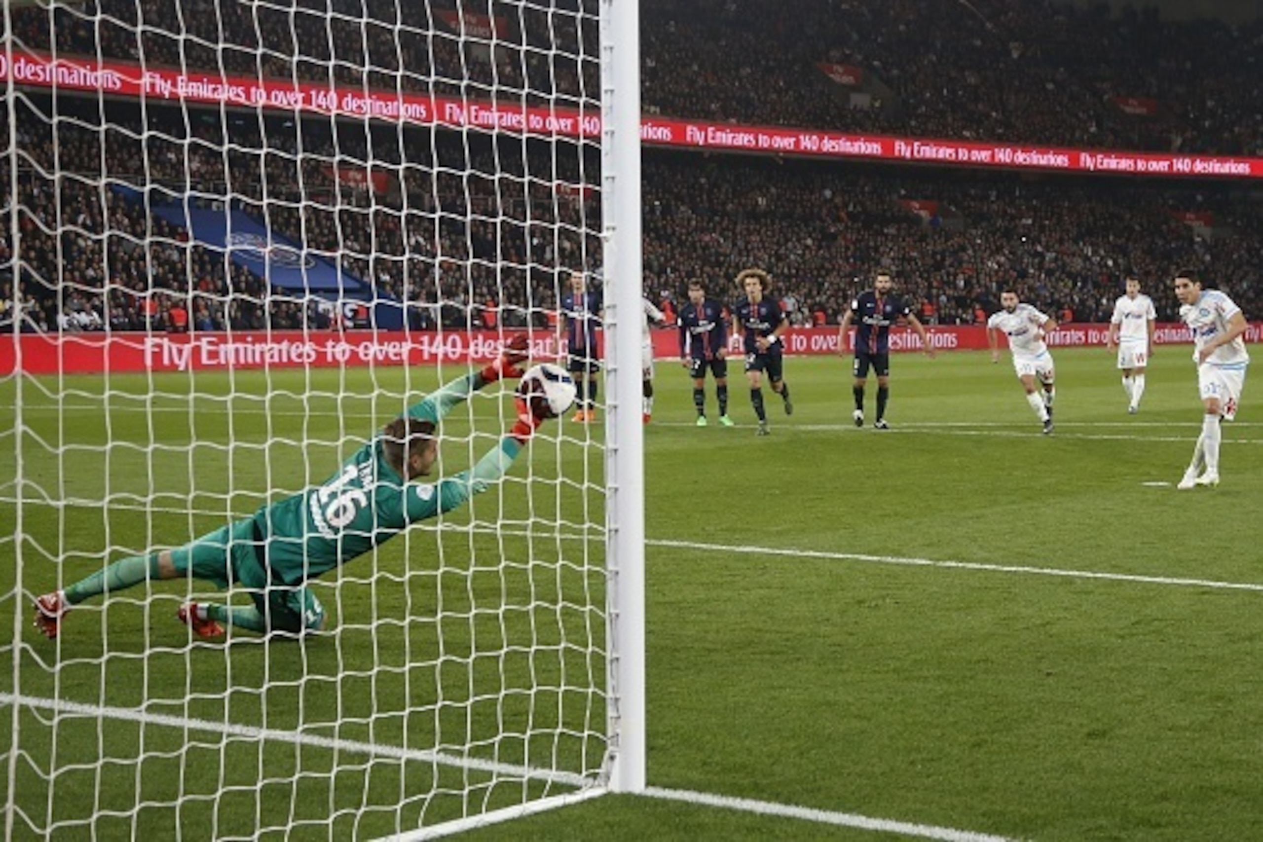 Paris Saint-Germain's German goalkeeper Kevin Trapp (L) stops a penatly kicked by Marseille's Moroccan midfielder Abdelaziz Barrada (R) during the French L1 football match Paris Saint-Germain (PSG) vs Olympique de Marseille (OM) on October 4, 2015 at the
