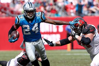TAMPA, FL - OCTOBER 4: Cornerback Josh Norman #24 of the Carolina Panthers stiif arms Guard Logan Mankins #70 of the Tampa Bay Buccaneers on a run back from his second interception of the game at Raymond James Stadium on October 4, 2015 in Tampa, Florida.