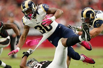 GLENDALE, AZ - OCTOBER 04: Running back Todd Gurley #30 of the St. Louis Rams is tripped up by defensive end Calais Campbell #93 of the Arizona Cardinals during the second half of the NFL game at the University of Phoenix Stadium on October 4, 2015 in Gle