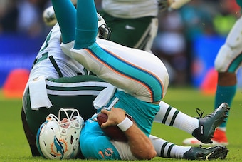 LONDON, ENGLAND - OCTOBER 04:  Ryan Tannehill #17 of the Miami Dolphins is sacked by David Harris #52 of the New York Jets during the game at Wembley Stadium on October 4, 2015 in London, England.  (Photo by Stephen Pond/Getty Images)