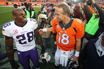 Oct 4, 2015; Denver, CO, USA; Denver Broncos quarterback Peyton Manning (18) and Minnesota Vikings running back Adrian Peterson (28) after the game at Sports Authority Field at Mile High. The Broncos won 23-20. Mandatory Credit: Chris Humphreys-USA TODAY