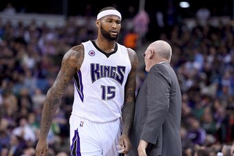 SACRAMENTO, CA - FEBRUARY 20:  DeMarcus Cousins #15 of the Sacramento Kings walks back to the bench past head coach George Karl after Cousins was called for a technical foul against the Boston Celtics in the first quarter at Sleep Train Arena on February 