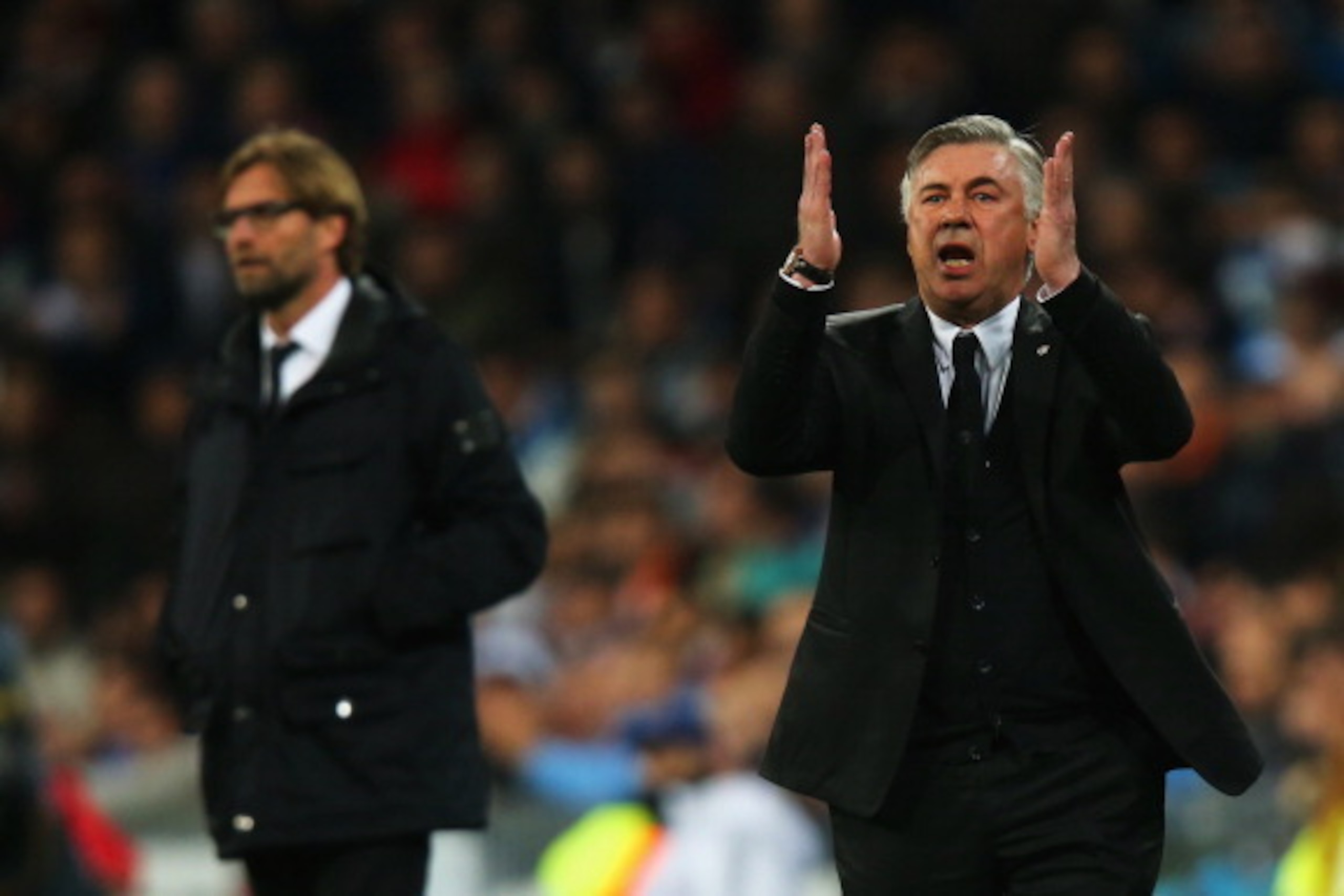 MADRID, SPAIN - APRIL 02:  Carlo Ancelotti, coach of Real Madrid reacts with Juergen Klopp, Coach of Borussia Dortmund during the UEFA Champions League Quarter Final first leg match between Real Madrid and Borussia Dortmund at Estadio Santiago Bernabeu on