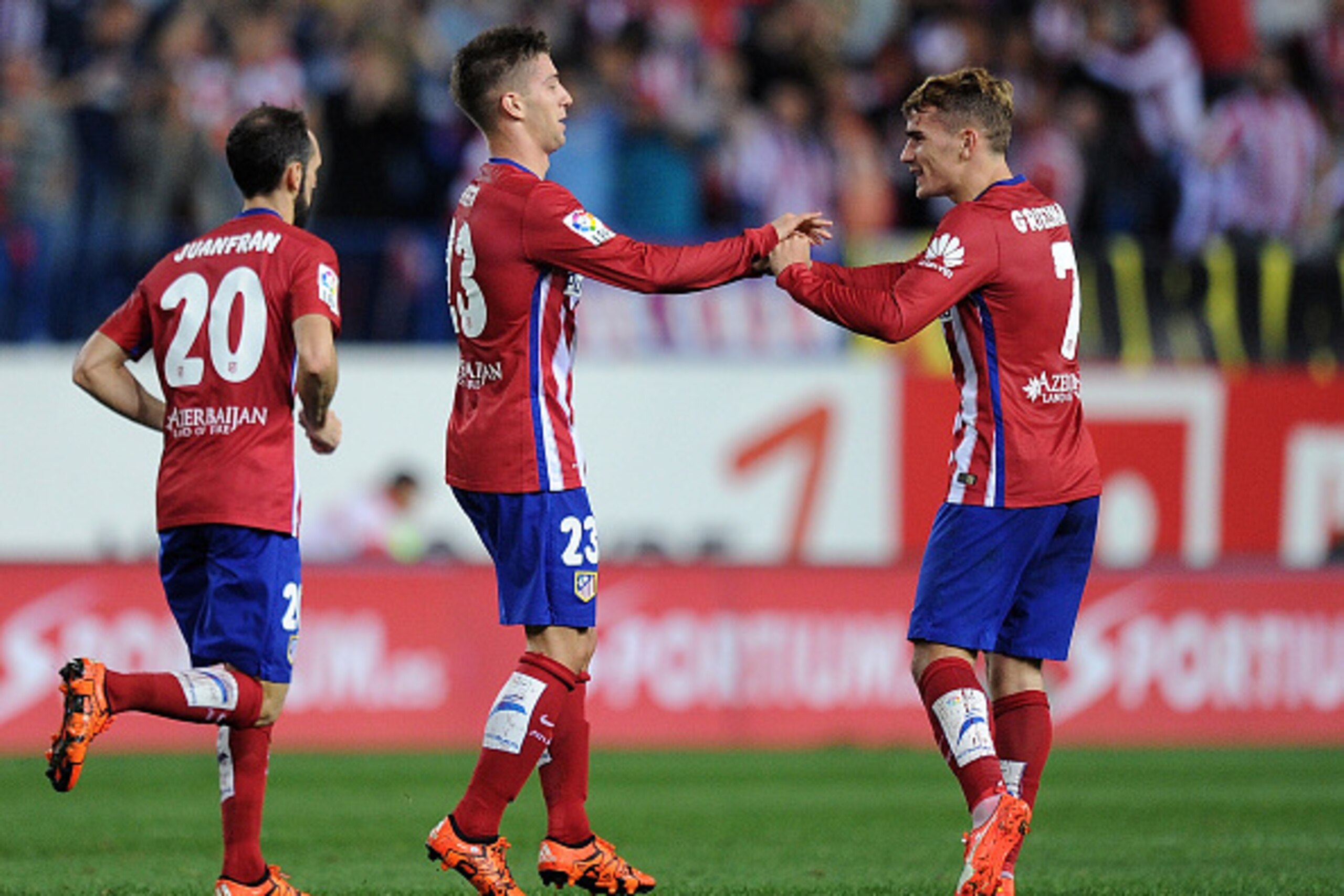MADRID, SPAIN - OCTOBER 04:  Luciano Vietto of Club Atletico de Madrid celebrates with  Antoine Greizmann after scoring Atletico's  opening goal during the La Liga match between Club Atletico de Madrid and Real Madrid at Vicente Calderon Stadium on Octobe