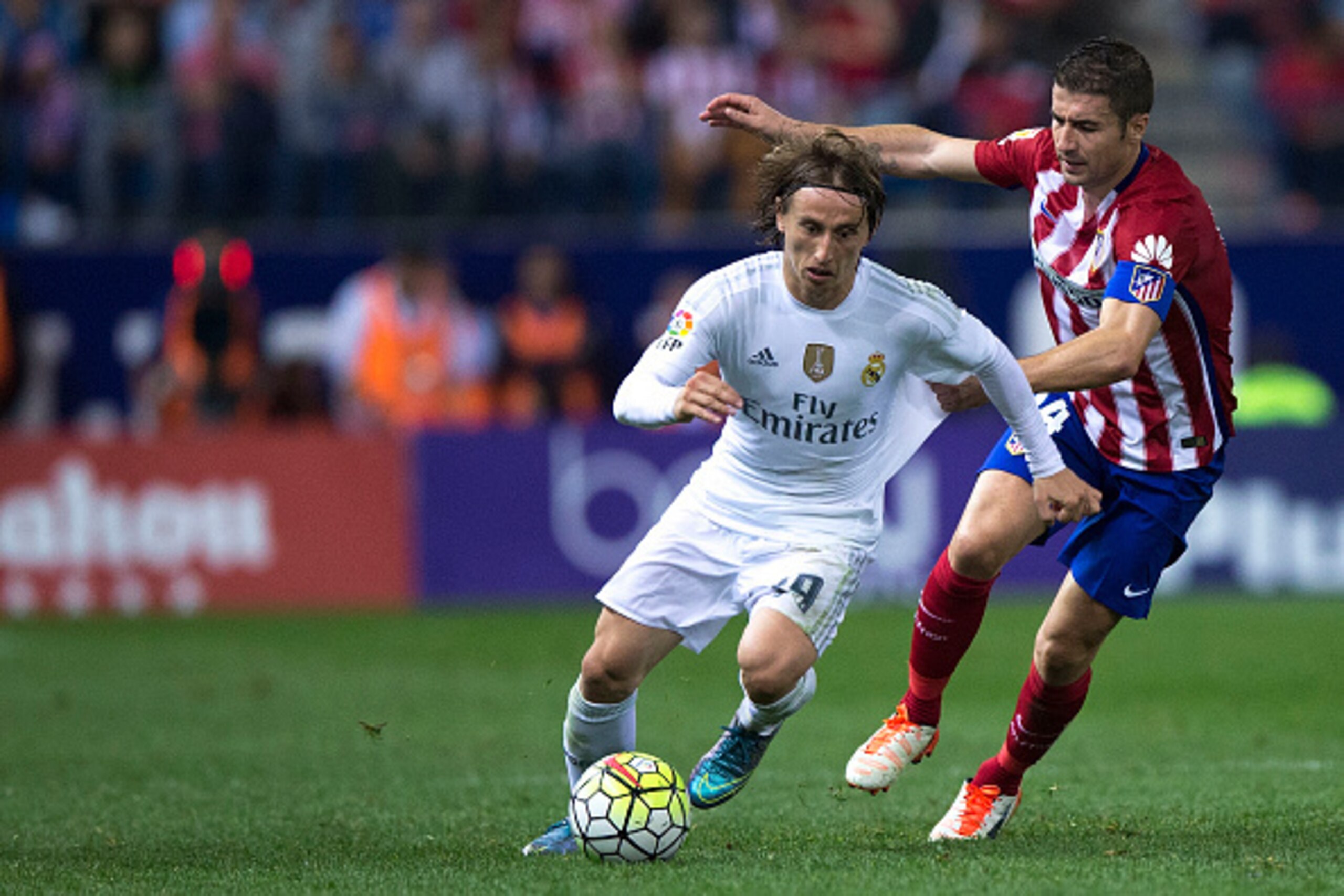 MADRID, SPAIN - OCTOBER 04: Luka Modric (R) of Atletico de Madrid competes for the ball with Gabi Fernandez (R) of Atletico de Madrid during the La Liga match between Club Atletico de Madrid and Real Madrid CF at Vicente Calderon Stadium on October 4, 201