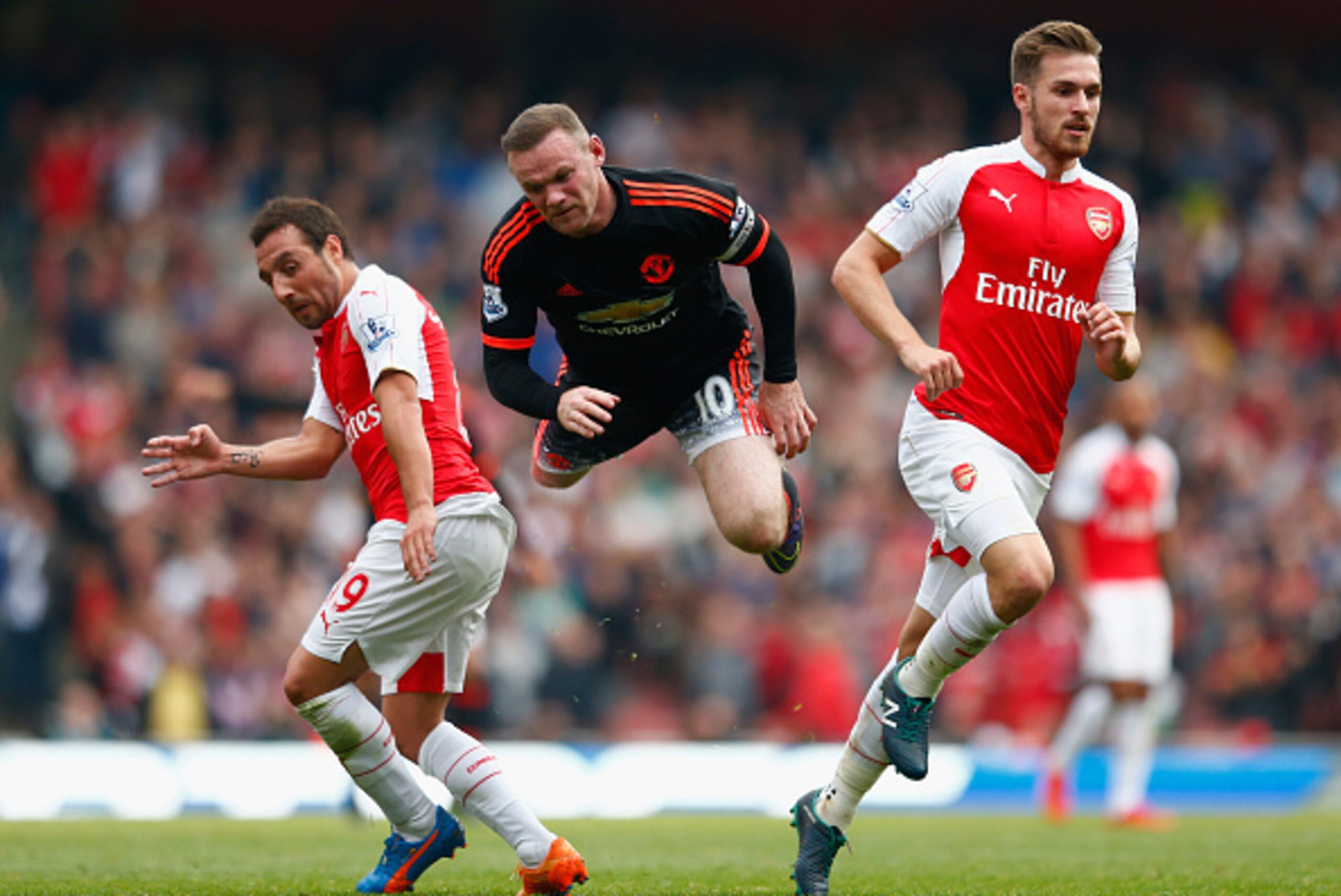LONDON, ENGLAND - OCTOBER 04:  Wayne Rooney of Manchester United is tackled by Santi Cazorla and Aaron Ramsey of Arsenal during the Barclays Premier League match between Arsenal and Manchester United at Emirates Stadium on October 4, 2015 in London, Engla