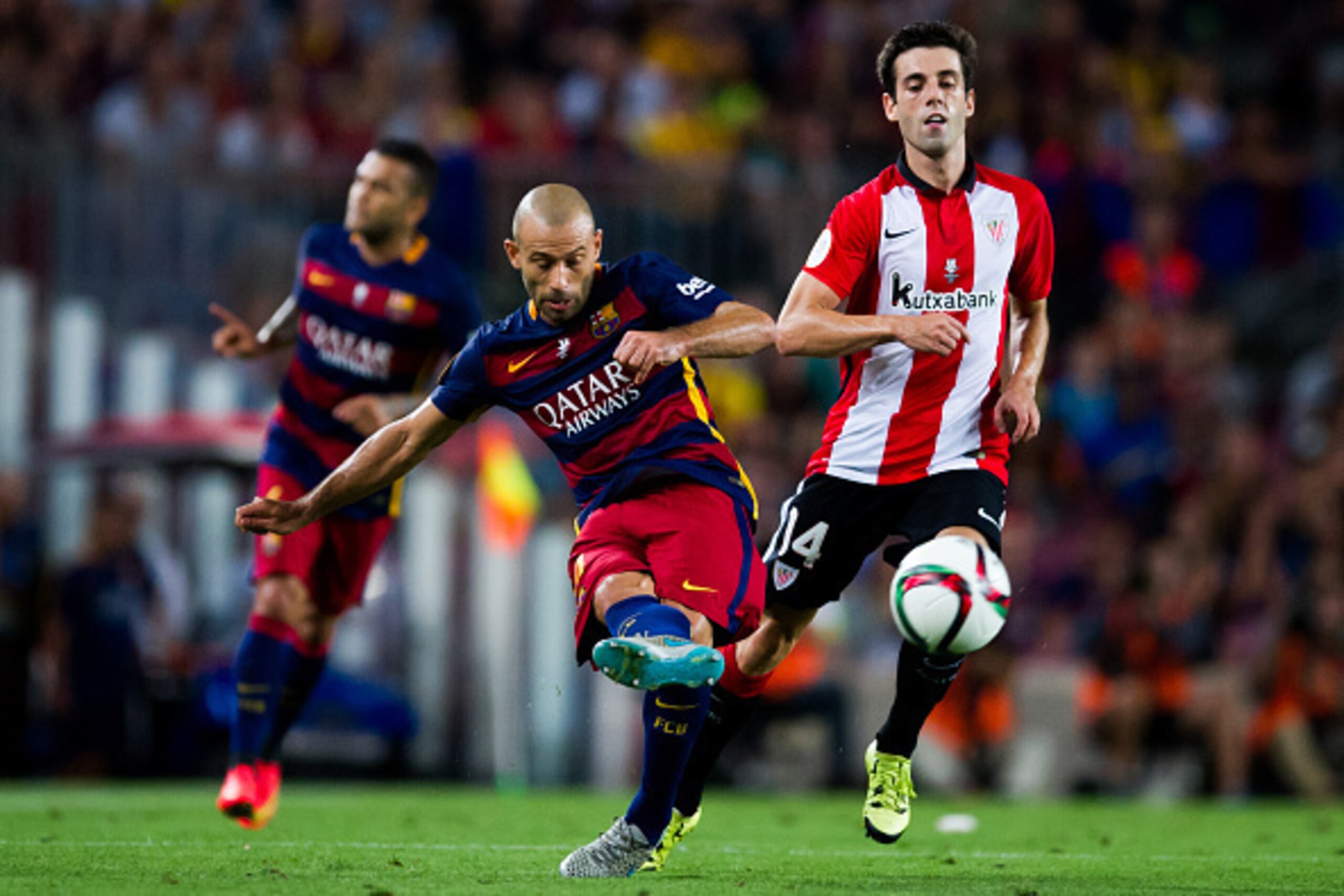 BARCELONA, SPAIN - AUGUST 17: Javier Mascherano of FC Barcelona makes a pass next to Markel Susaeta of Athletic Club during the Spanish Super Cup second leg match between FC Barcelona and Athletic Club at Camp Nou on August 17, 2015 in Barcelona, Spain. (