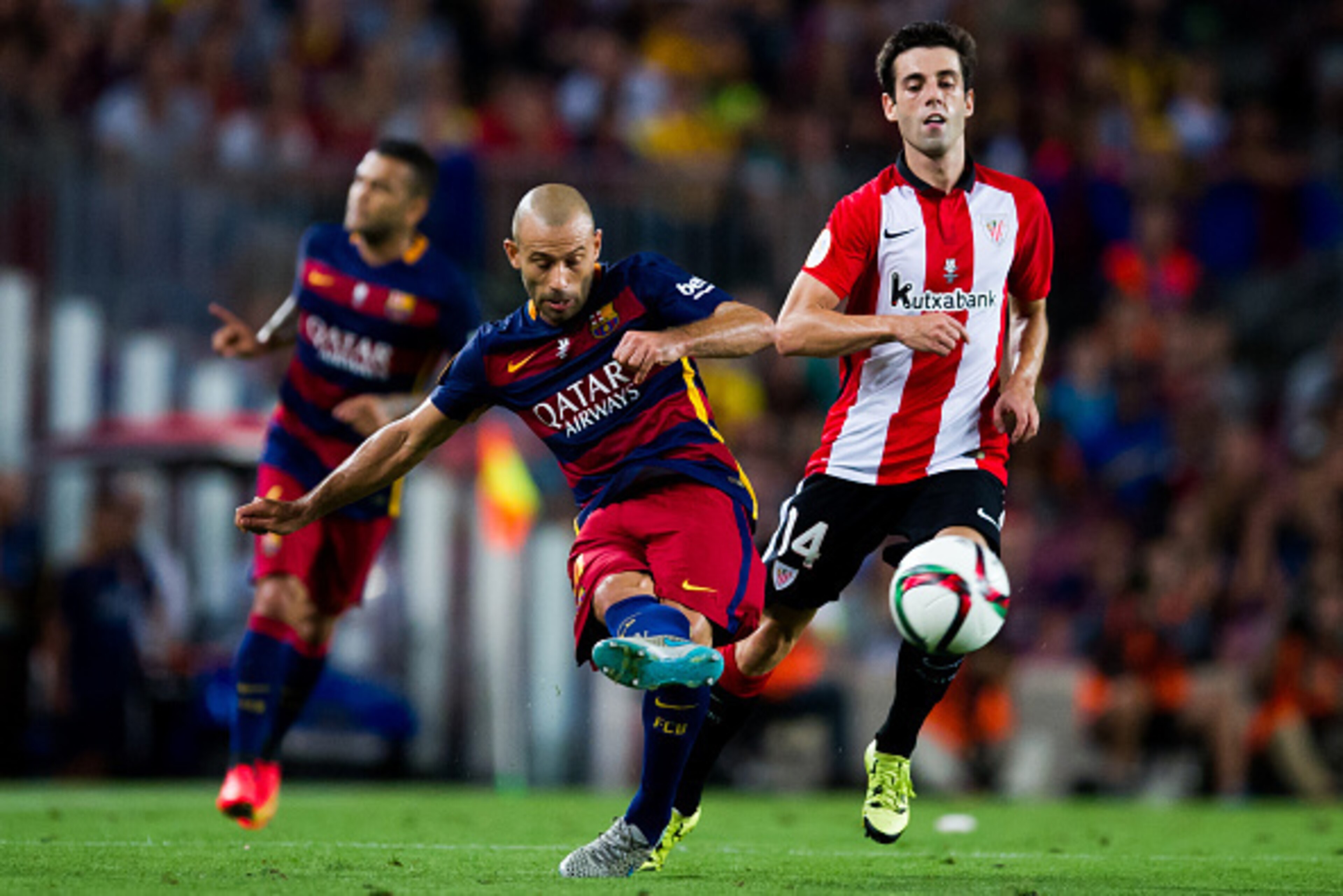 BARCELONA, SPAIN - AUGUST 17: Javier Mascherano of FC Barcelona makes a pass next to Markel Susaeta of Athletic Club during the Spanish Super Cup second leg match between FC Barcelona and Athletic Club at Camp Nou on August 17, 2015 in Barcelona, Spain. (