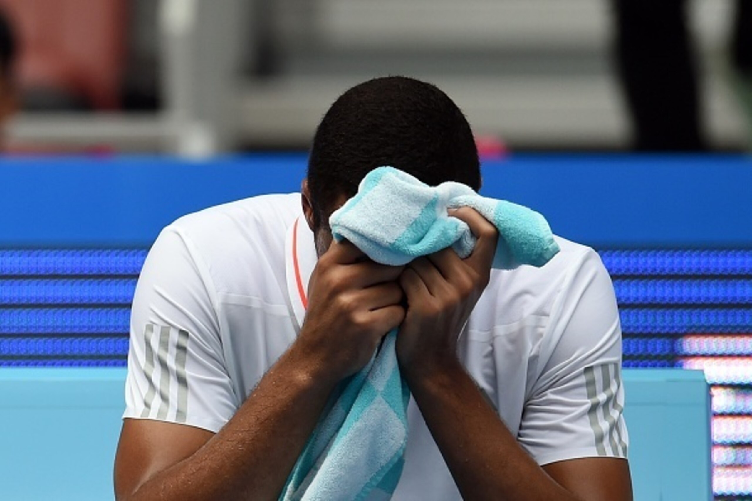 Jo-Wilfried Tsonga of France waits to get medical treatment during his first round men's singles match against Andreas Haider-Maurer of Austria at the China Open tennis tournament in Beijing on October 5, 2015. AFP PHOTO / GREG BAKER        (Photo credit 