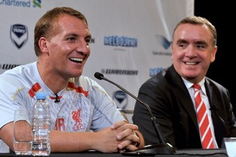 Liverpool manager Brendan Rodgers (L) smiles next to Managing Director Ian Ayre at a press conference in Melbourne on July 22, 2013. Rodgers said on July 22 he expects unsettled star Luis Suarez to stay with the club after the Uruguay striker arrived in A