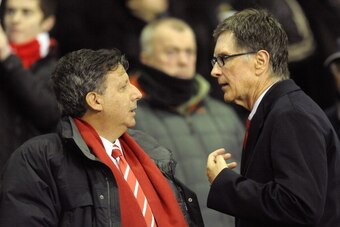 Liverpool owners Tom Werner (L) and John Henry speak before the English League cup semi final second leg football match between Liverpool and Manchester City at Anfield, Liverpool, north-west England, on January 25 2012. AFP PHOTO/ PAUL ELLIS. 

RESTRICTE