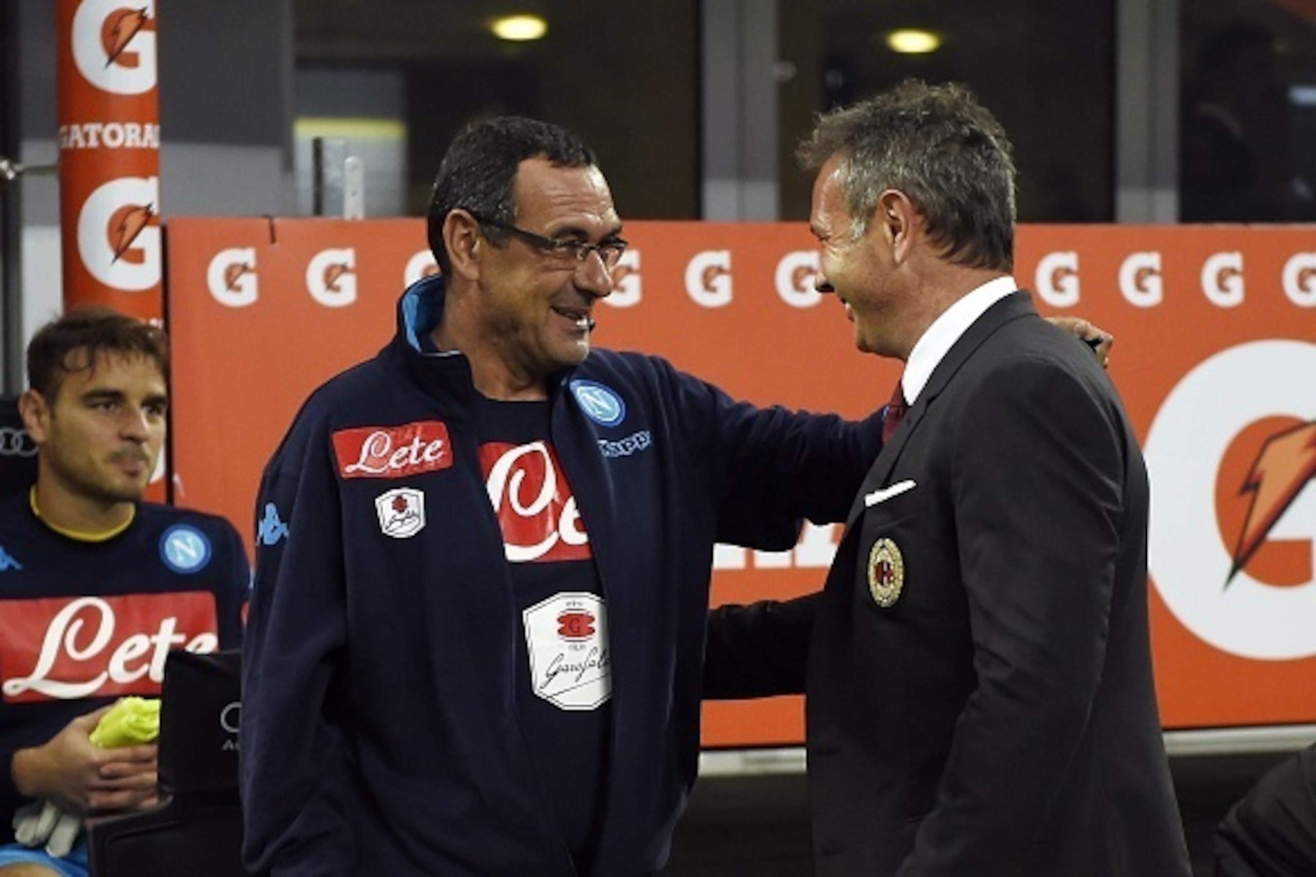 AC Milan's Serbian coach Sinisa Mihajlovic (R) talks to Napoli's Italian coach Maurizio Sarri before the Italian Serie A football match between AC Milan and Naples on October 4,  2015 at the San Siro Stadium in Milan. Naples won 4-0. AFP PHOTO / OLIVIER M