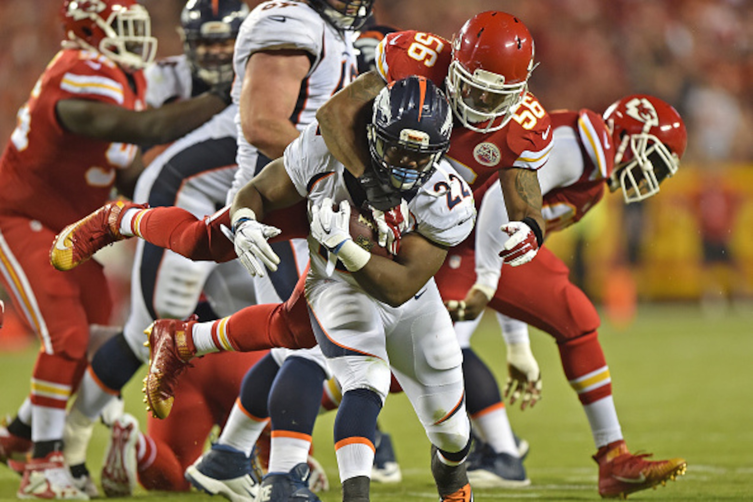 KANSAS CITY, MO - SEPTEMBER 17:  Linebacker Derrick Johnson #56 of the Kansas City Chiefs tackles running back C.J. Anderson #22 of the Denver Broncos during the first half at Arrowhead Stadium on September 17, 2015 in Kansas City, Missouri.  (Photo by Pe
