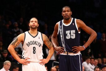 NEW YORK, NY - DECEMBER 04:  (NEW YORK DAILIES OUT)   Deron Williams #8 of the Brooklyn Nets and Kevin Durant #35 of the Oklahoma City Thunder look on during a timeout of their game at Barclays Center on December 4, 2012 in the Brooklyn borough of New Yor