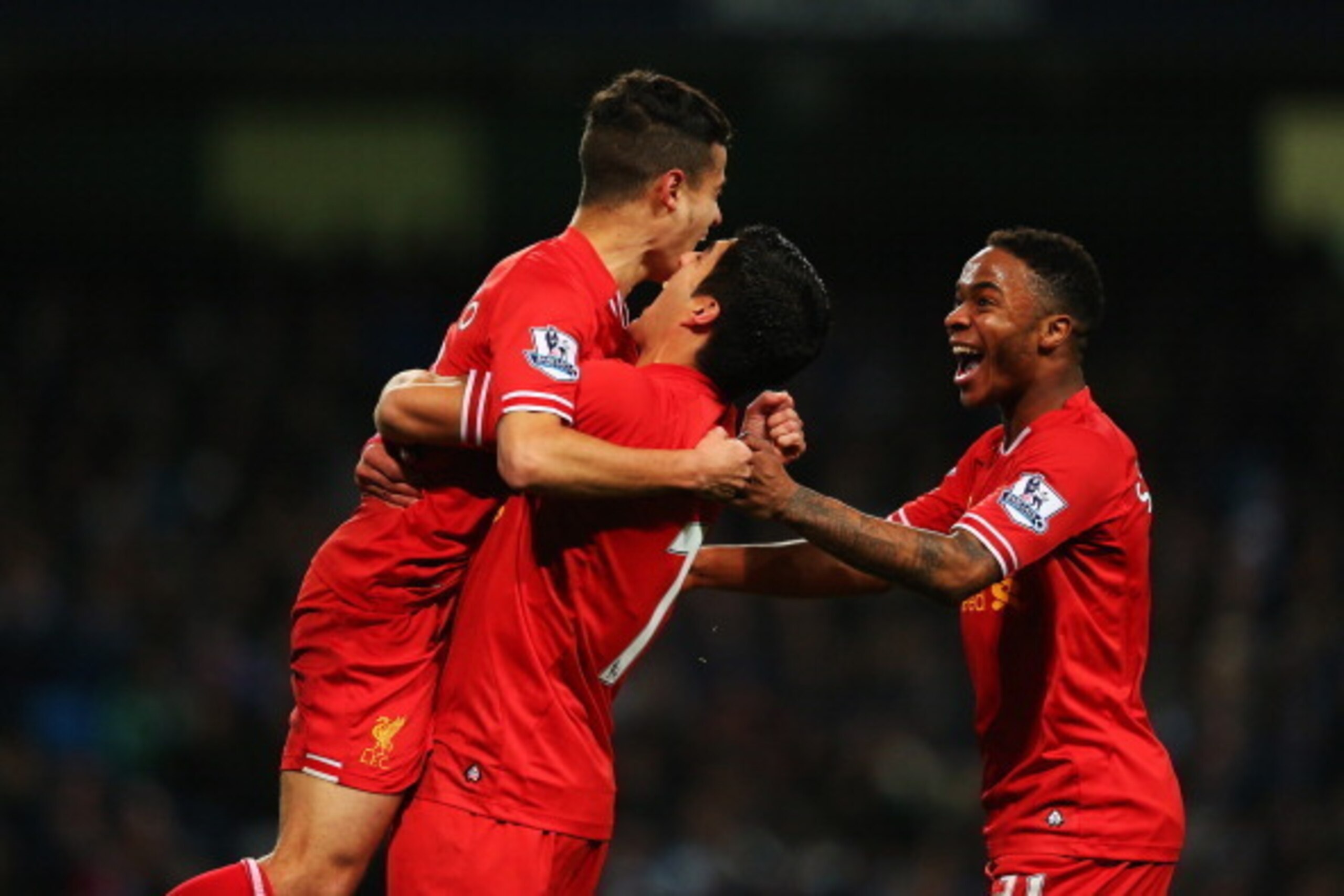 MANCHESTER, ENGLAND - DECEMBER 26:  Luis Suarez (C) and Raheem Sterling (R) of Liverpool congratulate goalscorer Philippe Coutinho during the Barclays Premier League match between Manchester City and Liverpool at Etihad Stadium on December 26, 2013 in Man