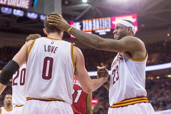 CLEVELAND, OH - FEBRUARY 11: LeBron James #23 of the Cleveland Cavaliers celebrates with Kevin Love #0  after scoring during the second half against the Miami Heat at Quicken Loans Arena on February 11, 2015 in Cleveland, Ohio. The Cavaliers defeated the 