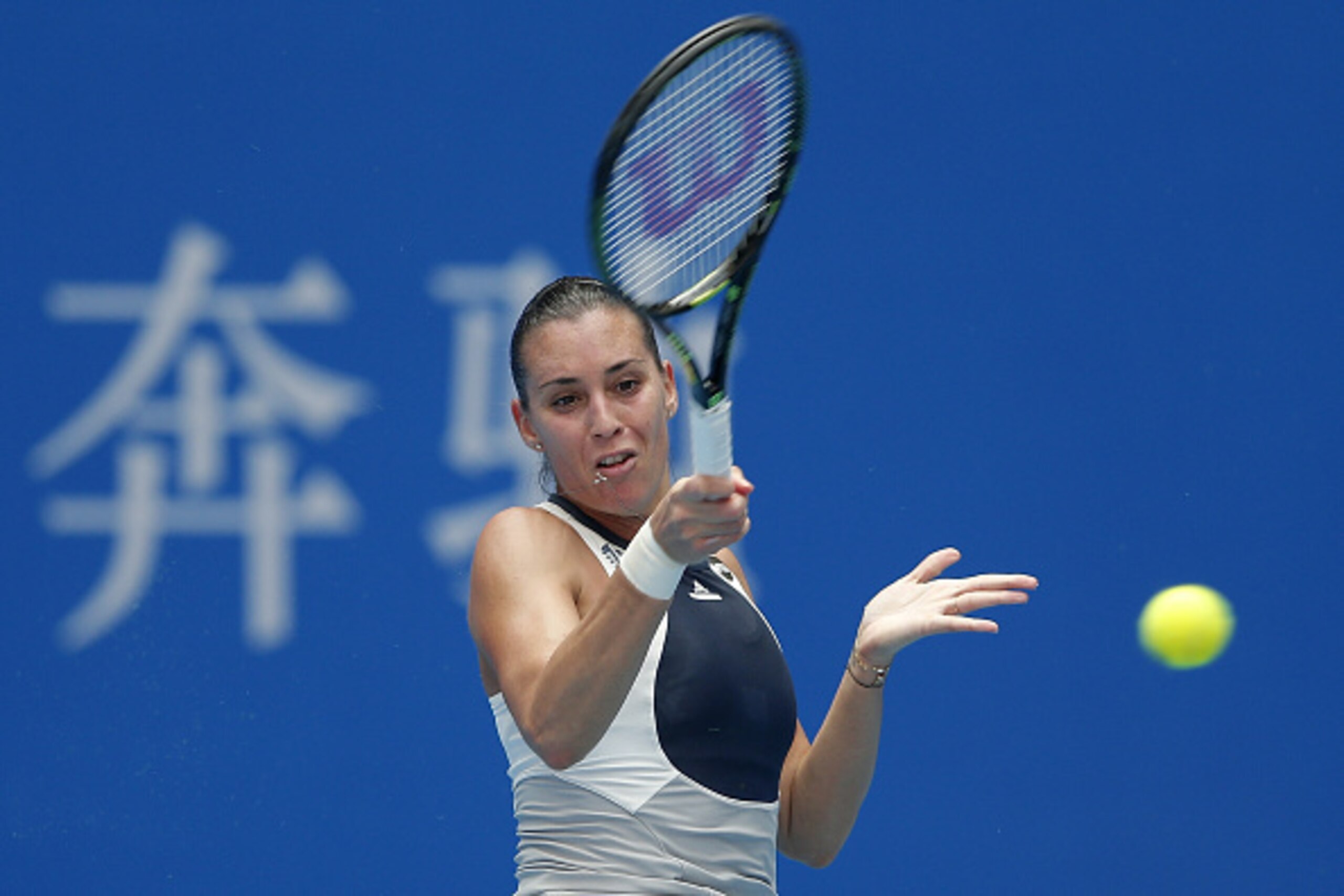BEIJING, CHINA - OCTOBER 04:  Flavia Pennetta of Italy returns a shot against Han Xinyuan of China during the day two of the 2015 China Open at the China National Tennis Centre on October 4, 2015 in Beijing, China.  (Photo by Lintao Zhang/Getty Images)
