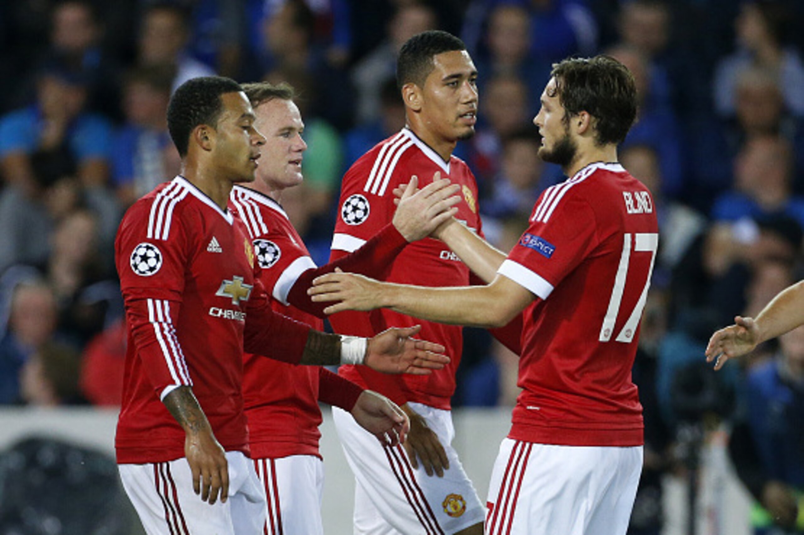 BRUGGE - AUGUST 26: Memphis Depay, Wayne Rooney, Chris Smalling and Daley Blind of Manchester United celebrate a goal during the UEFA Champions League play off round 2nd leg between Club Brugge KV and Manchester United on August 26, 2015 in Brugge, Belgiu