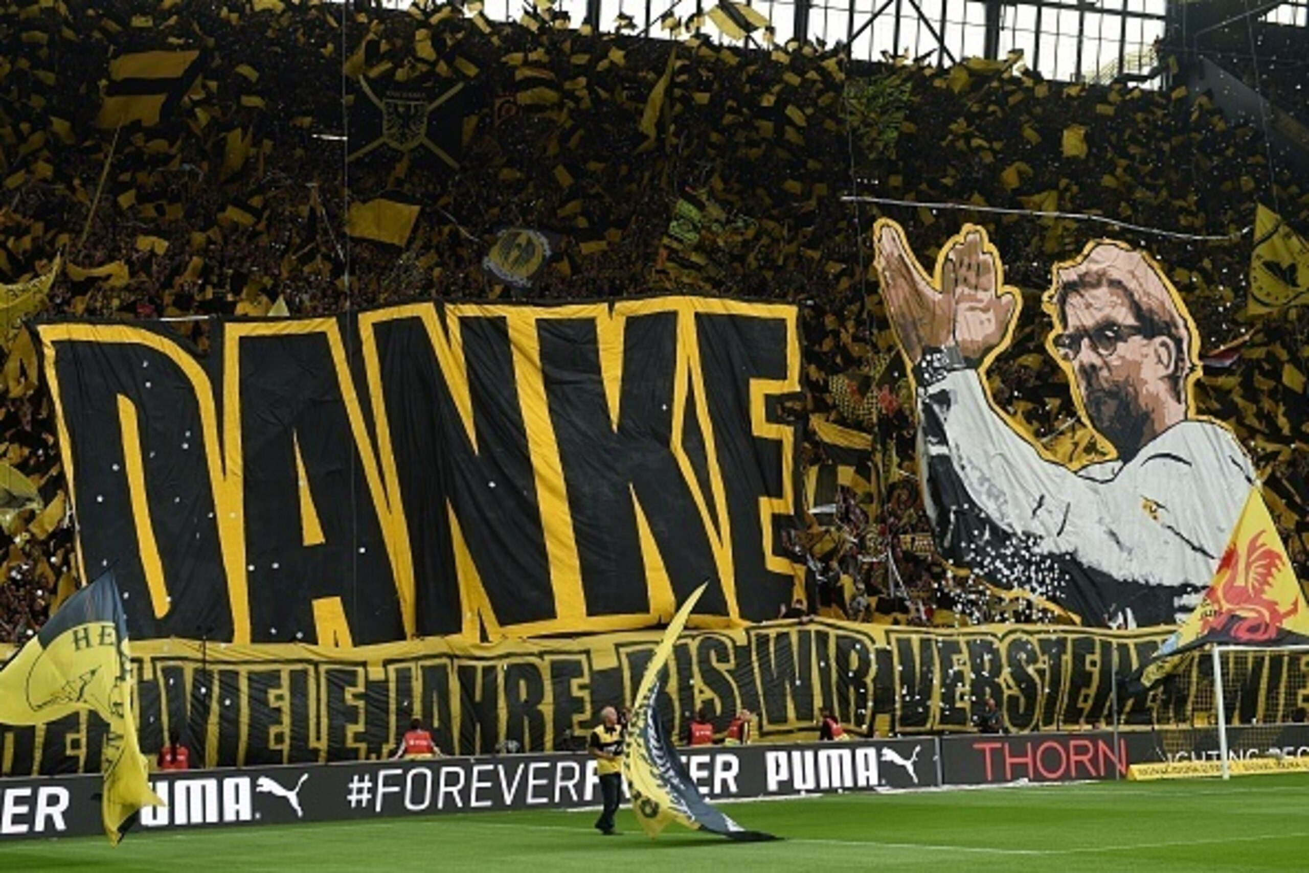 Dortmund's fans celebrate Dortmund's head coach Juergen Klopp prior to German first division Bundesliga football match between Borussia Dortmund and SV Werder Bremen at the Signal Iduna Park in Dortmund, western Germany on May 23, 2015. The match is Klopp