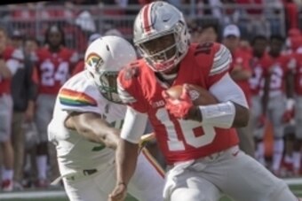 Sep 12, 2015; Columbus, OH, USA; Ohio State Buckeyes quarterback J.T. Barrett (16) rushes the ball in the second quarter of the game against the Hawaii Warriors at Ohio Stadium. Mandatory Credit: Trevor Ruszkowski-USA TODAY Sports