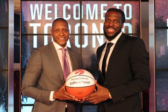 TORONTO, CANADA - JULY 9:  Masai Ujiri, GM of the Toronto Raptors, introduces DeMarre Carroll during a press conference on July 9, 2015 at the Air Canada Centre in Toronto, Ontario, Canada.  NOTE TO USER: User expressly acknowledges and agrees that, by do