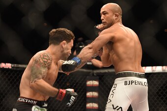 LAS VEGAS, NV - JULY 06:  (R-L) BJ Penn punches Frankie Edgar in their featherweight fight during The Ultimate Fighter Finale event at the Mandalay Bay Events Center on July 6, 2014 in Las Vegas, Nevada. (Photo by Jeff Bottari/Zuffa LLC/Zuffa LLC via Gett