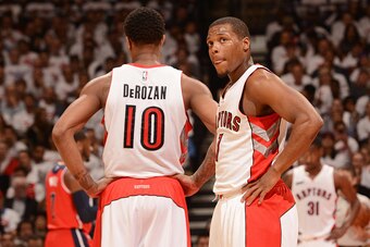 TORONTO, CANADA - April 21: DeMar DeRozan #10 and Kyle Lowry #7 of the Toronto Raptors speak during a game against the Washington Wizards during Game Two of the Eastern Conference Quarterfinals of the NBA Playoffs on April 21, 2015 at the Air Canada Centr