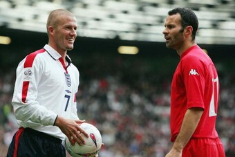 MANCHESTER, ENGLAND - OCTOBER 9:  David Beckham of England and Ryan Giggs of Wales share an exchange during the 2006 World Cup Qualifying match between England and Wales at Old Trafford, on October 9, 2004 in Manchester, England.  (Photo by Laurence Griff