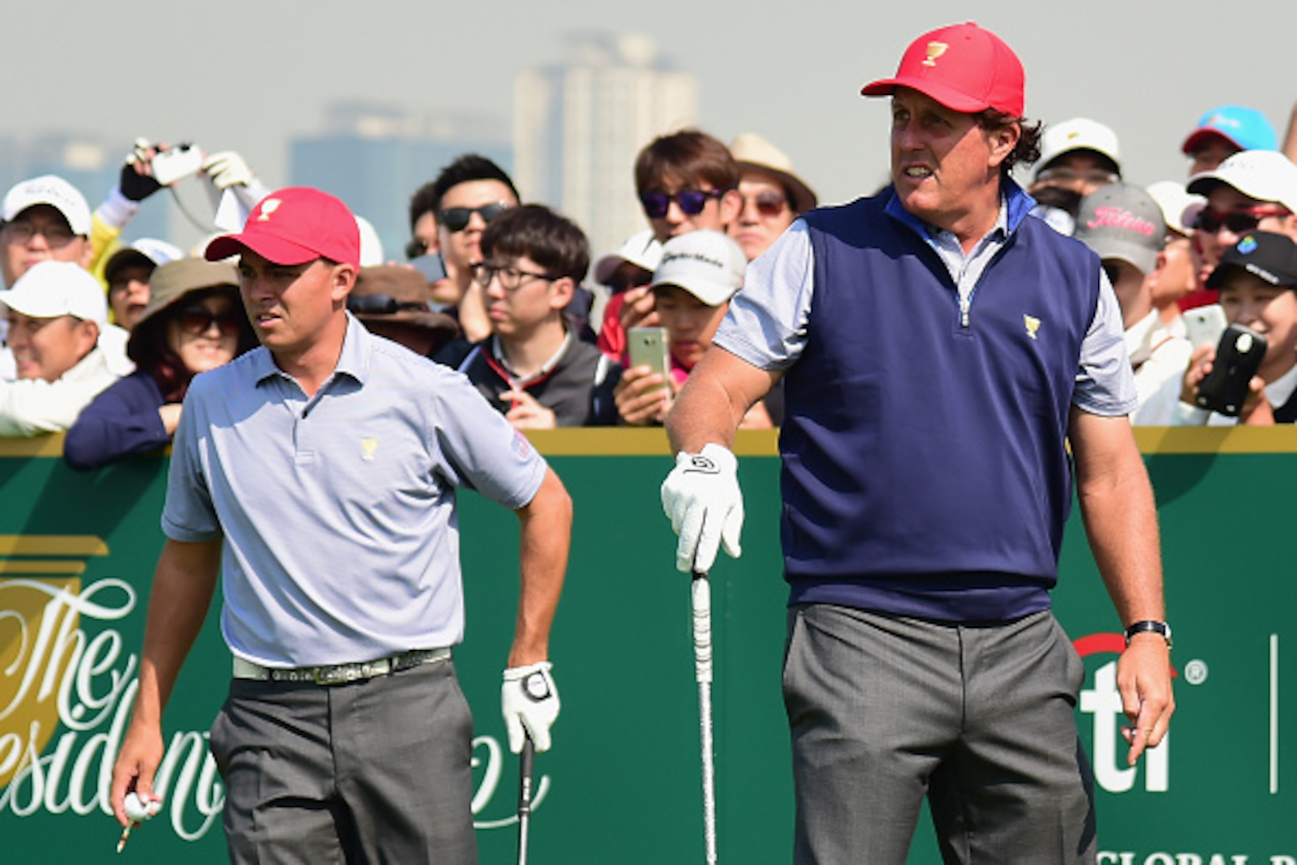 INCHEON CITY, SOUTH KOREA - OCTOBER 06:  Phil Mickelson (R) and Rickie Fowler of the United States team watch a tee shot on the practice ground  prior to the start of The Presidents Cup at the Jack Nicklaus Golf Club on October 6, 2015 in  Incheon City, S