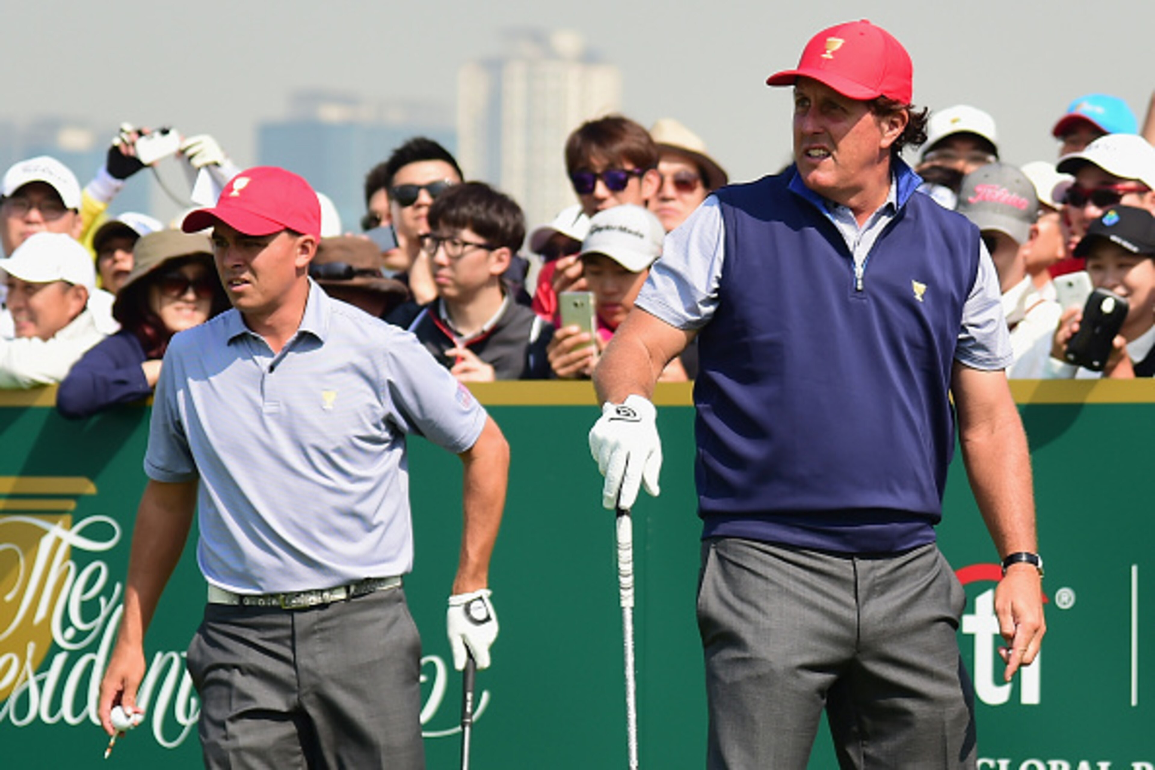 INCHEON CITY, SOUTH KOREA - OCTOBER 06:  Phil Mickelson (R) and Rickie Fowler of the United States team watch a tee shot on the practice ground  prior to the start of The Presidents Cup at the Jack Nicklaus Golf Club on October 6, 2015 in  Incheon City, S