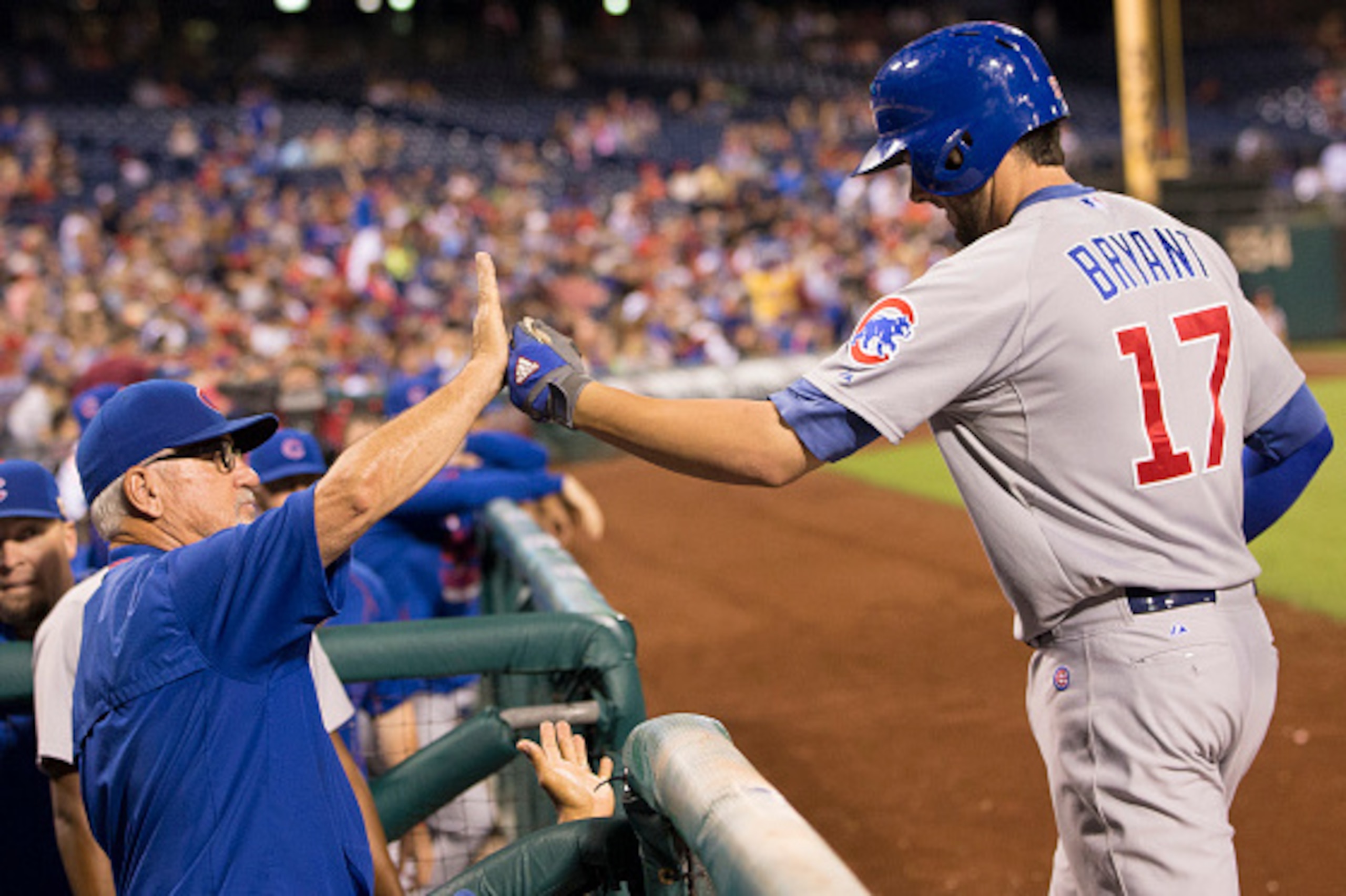 PHILADELPHIA, PA - SEPTEMBER 11: Manager Joe Maddon #70 of the Chicago Cubs high fives Kris Bryant #17 after a two-run homerun by Bryant in the top of the fifth inning against the Philadelphia Phillies on September 11, 2015 at Citizens Bank Park in Philad PHILADELPHIA, PA - SEPTEMBER 11: Manager Joe Maddon #70 of the Chicago Cubs high fives Kris Bryant #17 after a two-run homerun by Bryant in the top of the fifth inning against the Philadelphia Phillies on September 11, 2015 at Citizens Bank Park in Philad