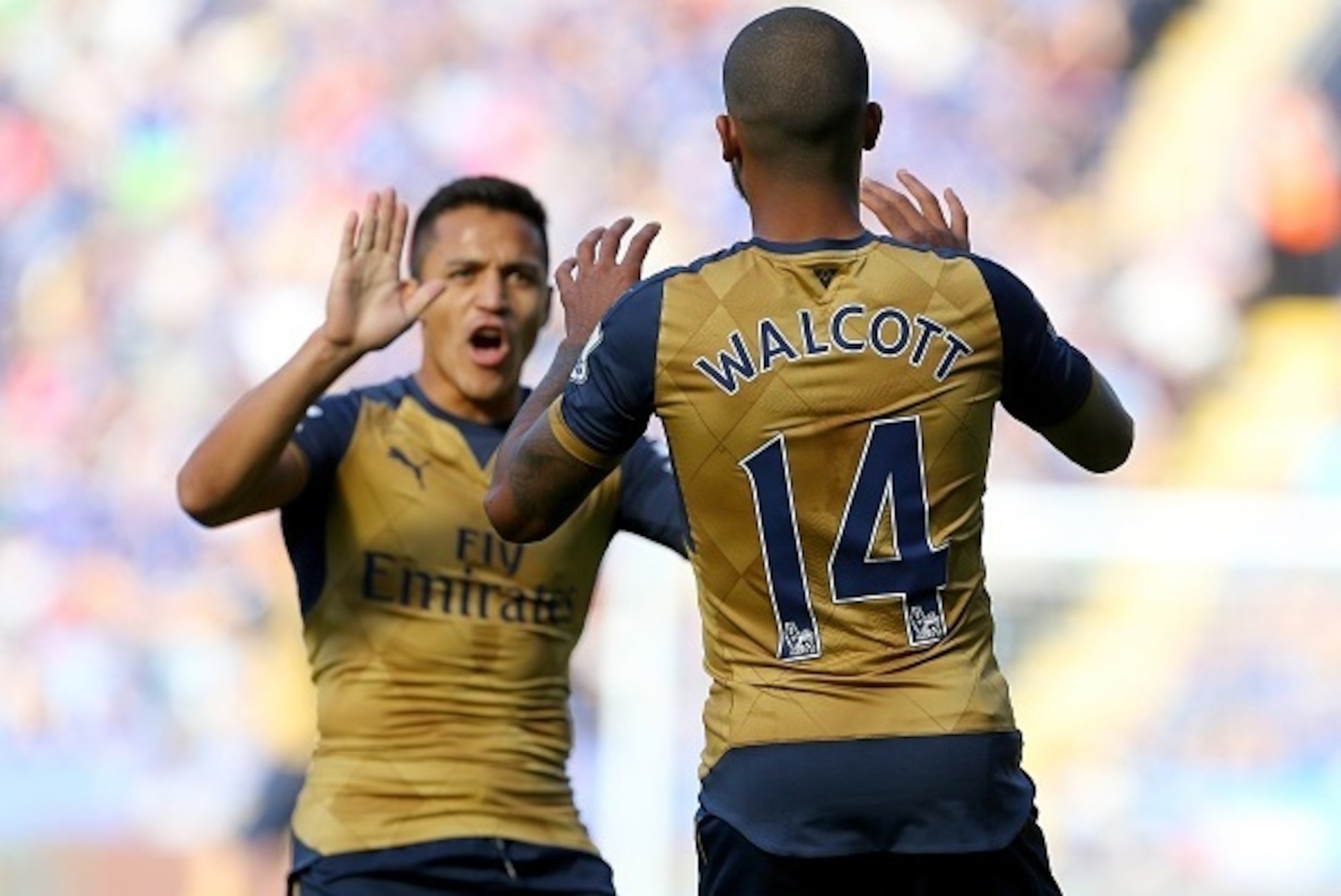 Arsenals English striker Theo Walcott (R) celebrates with Arsenal's Chilean striker Alexis Sanchez after Walcott socred his team's opening goal during the English Premier League football match between Leicester City and Arsenal at King Power Stadium in Le