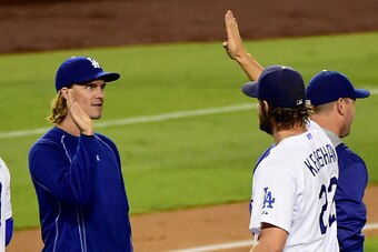 LOS ANGELES, CA - SEPTEMBER 02:  Zack Greinke #21 of the Los Angeles Dodgers celebrates a 2-1 complete game win by Clayton Kershaw #22 over the San Francisco Giants at Dodger Stadium on September 2, 2015 in Los Angeles, California.  (Photo by Harry How/Ge